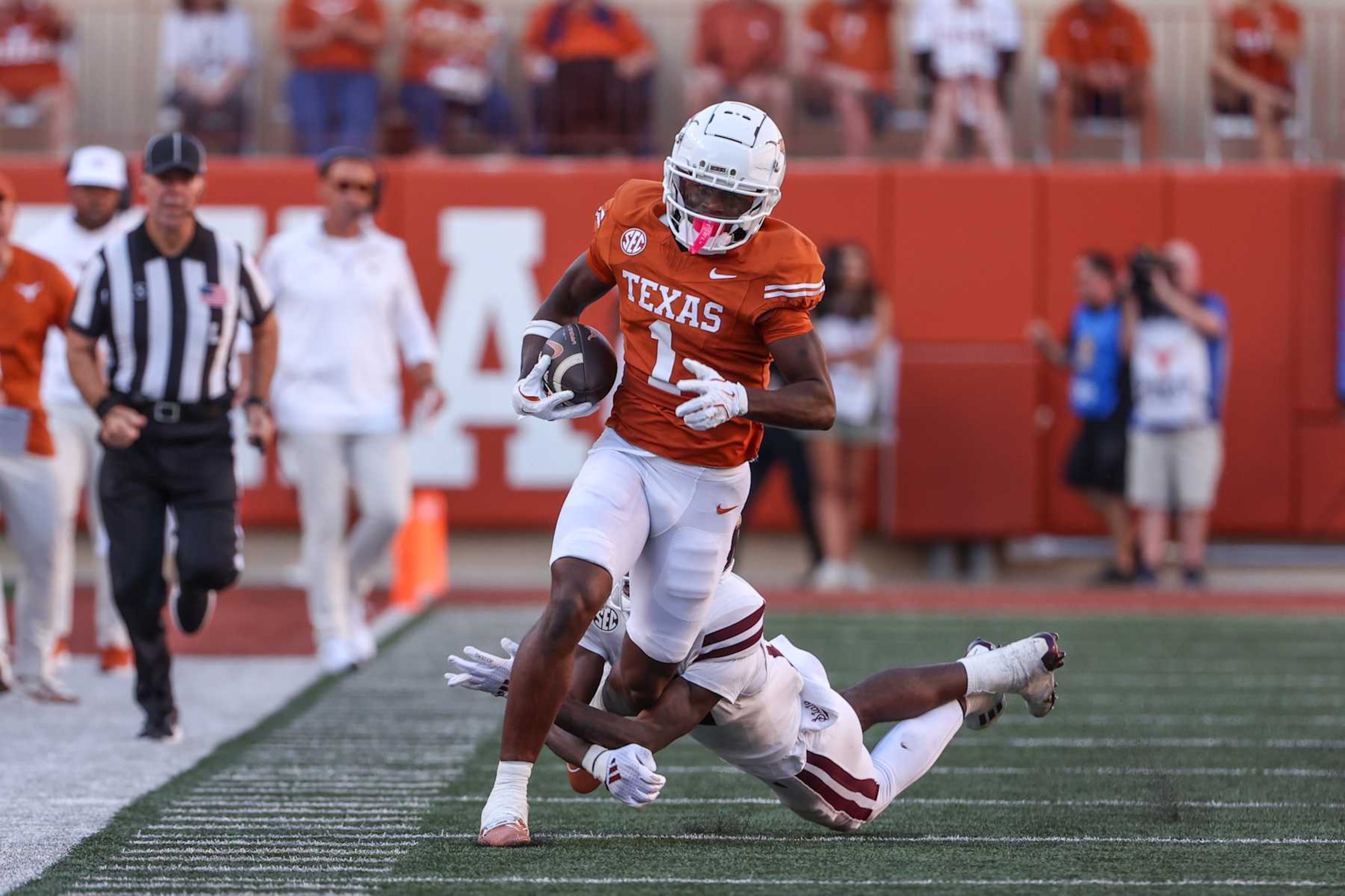 AUSTIN, TX - SEPTEMBER 28: Texas Longhorns wide receiver Johntay Cook II (1) races down the sidelines after a catch as he is tackled by a Mississippi State Bulldogs defender during the SEC college football game between Texas Longhorns and Mississippi State Bulldogs on September 28, 2024, at Darrell K Royal - Texas Memorial Stadium in Austin, TX.  (Photo by David Buono/Icon Sportswire via Getty Images)