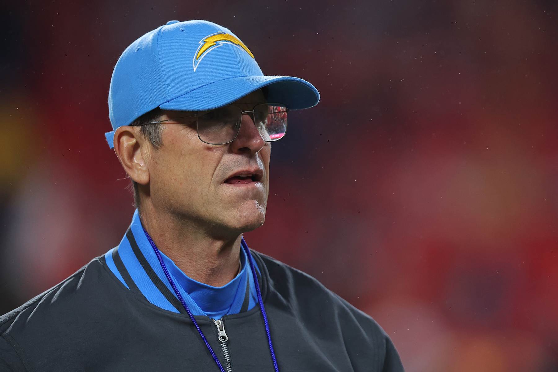 KANSAS CITY, MISSOURI - DECEMBER 08: Head coach Jim Harbaugh of the Los Angeles Chargers looks on during warm ups prior to the game against the Kansas City Chiefs at GEHA Field at Arrowhead Stadium on December 08, 2024 in Kansas City, Missouri. (Photo by David Eulitt/Getty Images)