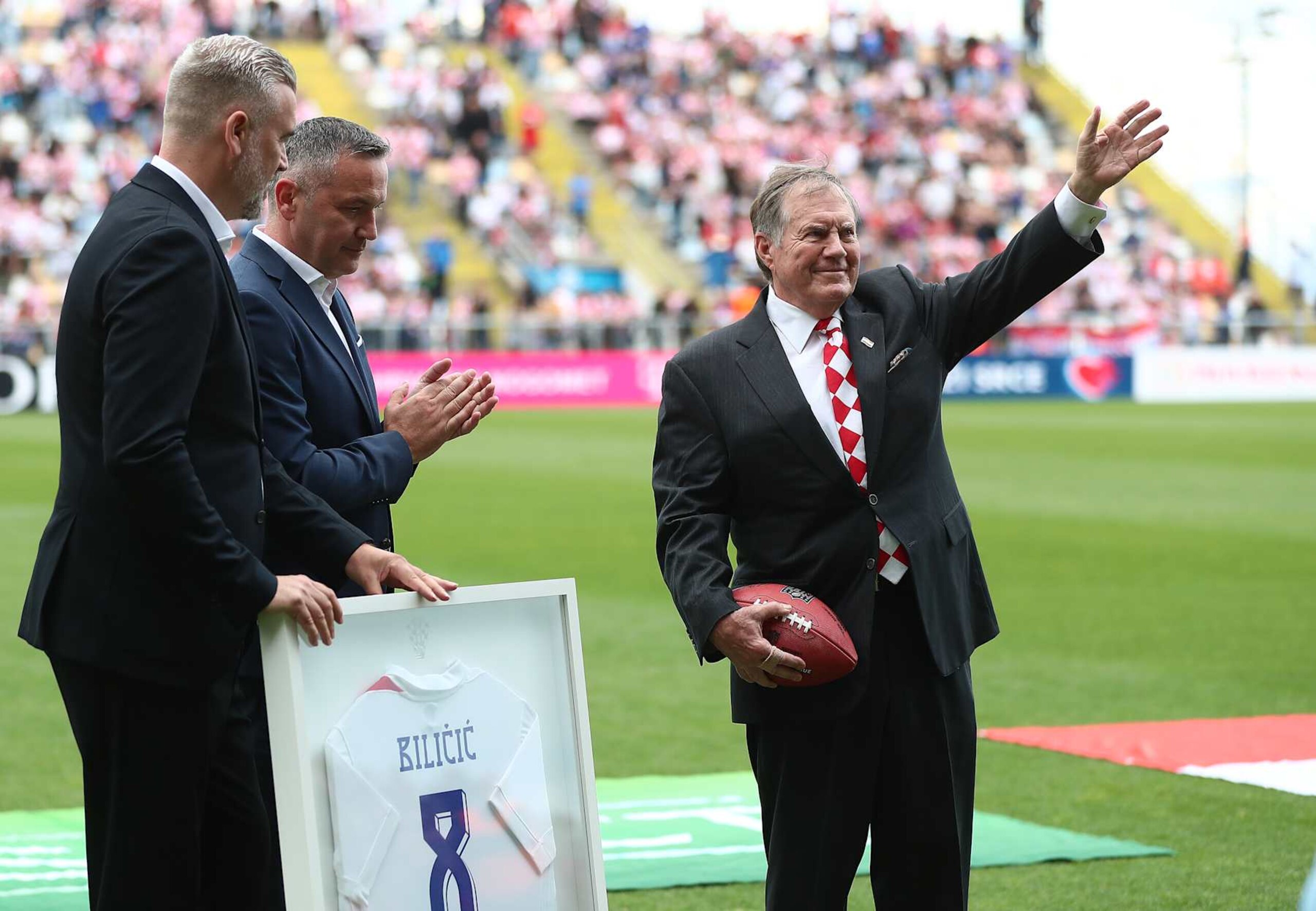 RIJEKA, CROATIA - JUNE 3: American football coach with Croatian origin Bill Belichick (C) who won eight Super Bowl titles gave Croatian Football Federation a NFL ball, while CFF gave him the jersey  at an International Friendly match between Croatia and North Macedonia at Stadion HNK Rijeka on June 3, 2024 in Rijeka, Croatia.  (Photo by Matija Habljak/Pixsell/MB Media/Getty Images)