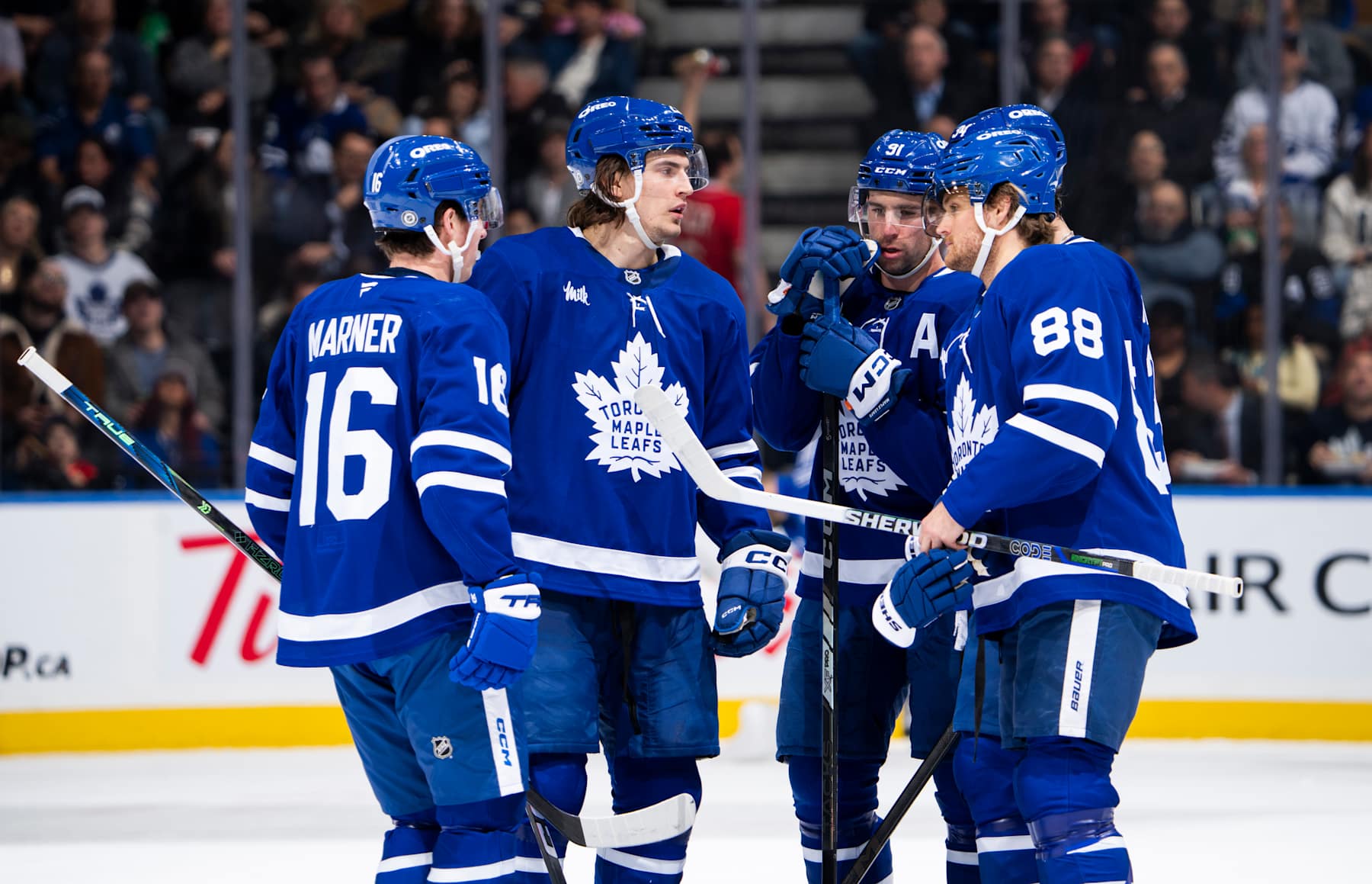 TORONTO, ON - DECEMBER 4: Mitchell Marner #16, Matthew Knies #23, John Tavares #91 and William Nylander #88 of the Toronto Maple Leafs speak in a break in play against the Nashville Predators during the first period at the Scotiabank Arena on December 4, 2024 in Toronto, Ontario, Canada. (Photo by Mark Blinch/NHLI via Getty Images)