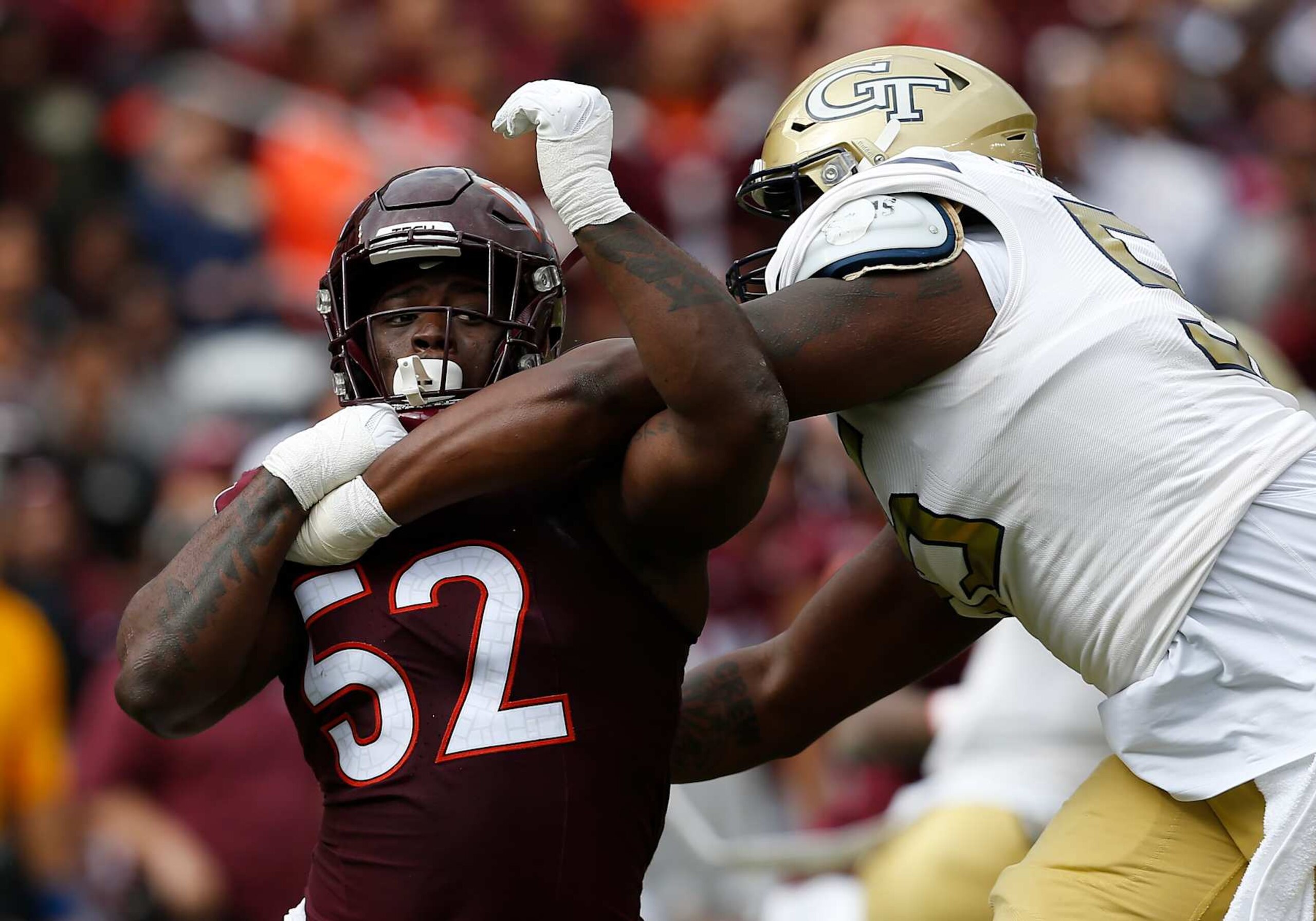 BLACKSBURG, VA - OCTOBER 26: Georgia Tech Yellow Jackets offensive lineman Corey Robinson II (55) attempts to block Virginia Tech Hokies defensive lineman Antwaun Powell-Ryland (52) during a college football game between the Georgia Tech Yellow Jackets and the Virginia Tech Hokies on October 26, 2024, at Lane Stadium in Blacksburg, VA. (Photo by Lee Coleman/Icon Sportswire via Getty Images)