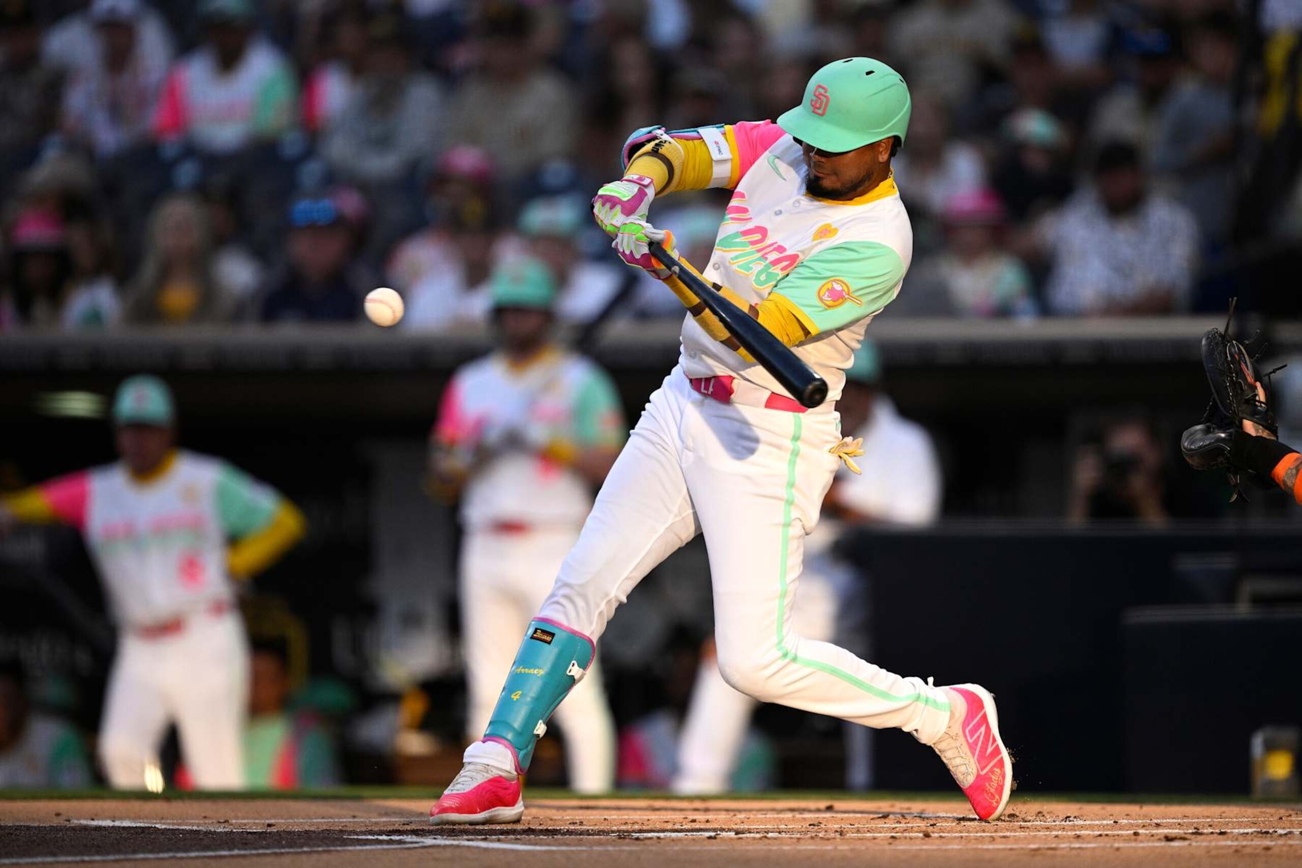 SAN DIEGO, CALIFORNIA - AUGUST 23: Luis Arraez #4 of the San Diego Padres hits a home run against the New York Mets during the first inning at Petco Park on August 23, 2024 in San Diego, California. (Photo by Orlando Ramirez/Getty Images)