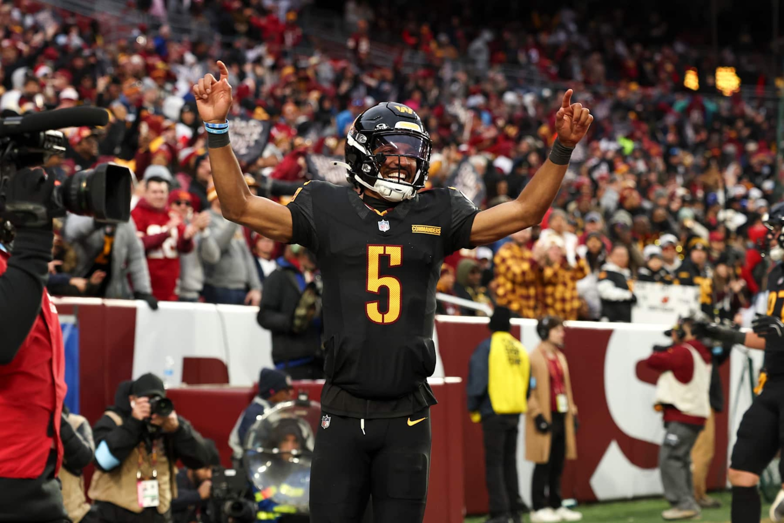 LANDOVER, MARYLAND - DECEMBER 01: Jayden Daniels #5 of the Washington Commanders celebrates a touchdown during a game against the Tennessee Titans at Northwest Stadium on December 01, 2024 in Landover, Maryland. The Commanders defeated the Titans 42-19. (Kara Durrette/Getty Images) LANDOVER, MARYLAND - DECEMBER 01: Jayden Daniels #5 of the Washington Commanders celebrates a touchdown during a game against the Tennessee Titans at Northwest Stadium on December 01, 2024 in Landover, Maryland. The Commanders defeated the Titans 42-19. (Kara Durrette/Getty Images)
