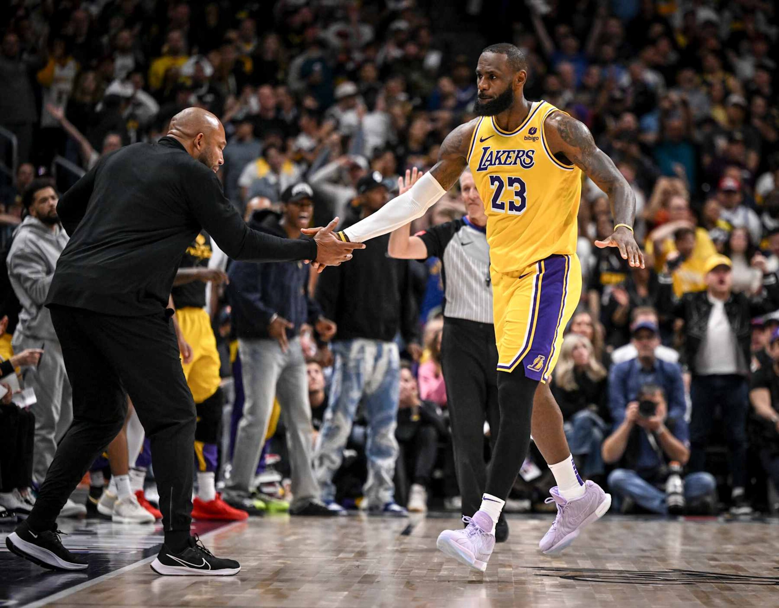 DENVER, CO - APRIL 22: LeBron James (23) of the Los Angeles Lakers celebrates earning a free throw, while making a shot with head coach Darvin Ham during the fourth quarter of the Denver Nuggets' 101-99 win at Ball Arena in Denver on Monday, April 22, 2024. (Photo by AAron Ontiveroz/The Denver Post)