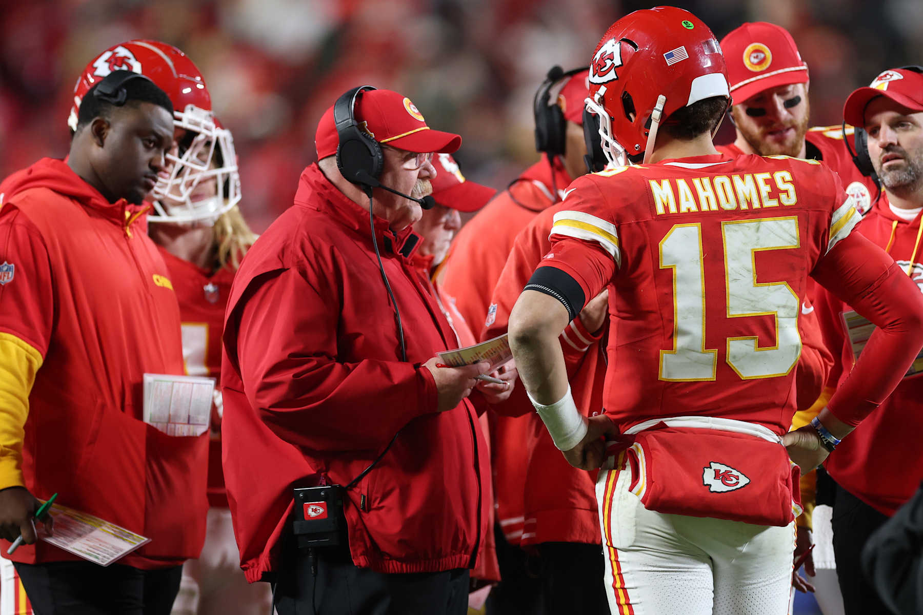 KANSAS CITY, MISSOURI - DECEMBER 08: Head coach Andy Reid of the Kansas City Chiefs speaks to Patrick Mahomes #15 during the fourth quarter against the Los Angeles Chargers at GEHA Field at Arrowhead Stadium on December 08, 2024 in Kansas City, Missouri. (Photo by Jamie Squire/Getty Images)