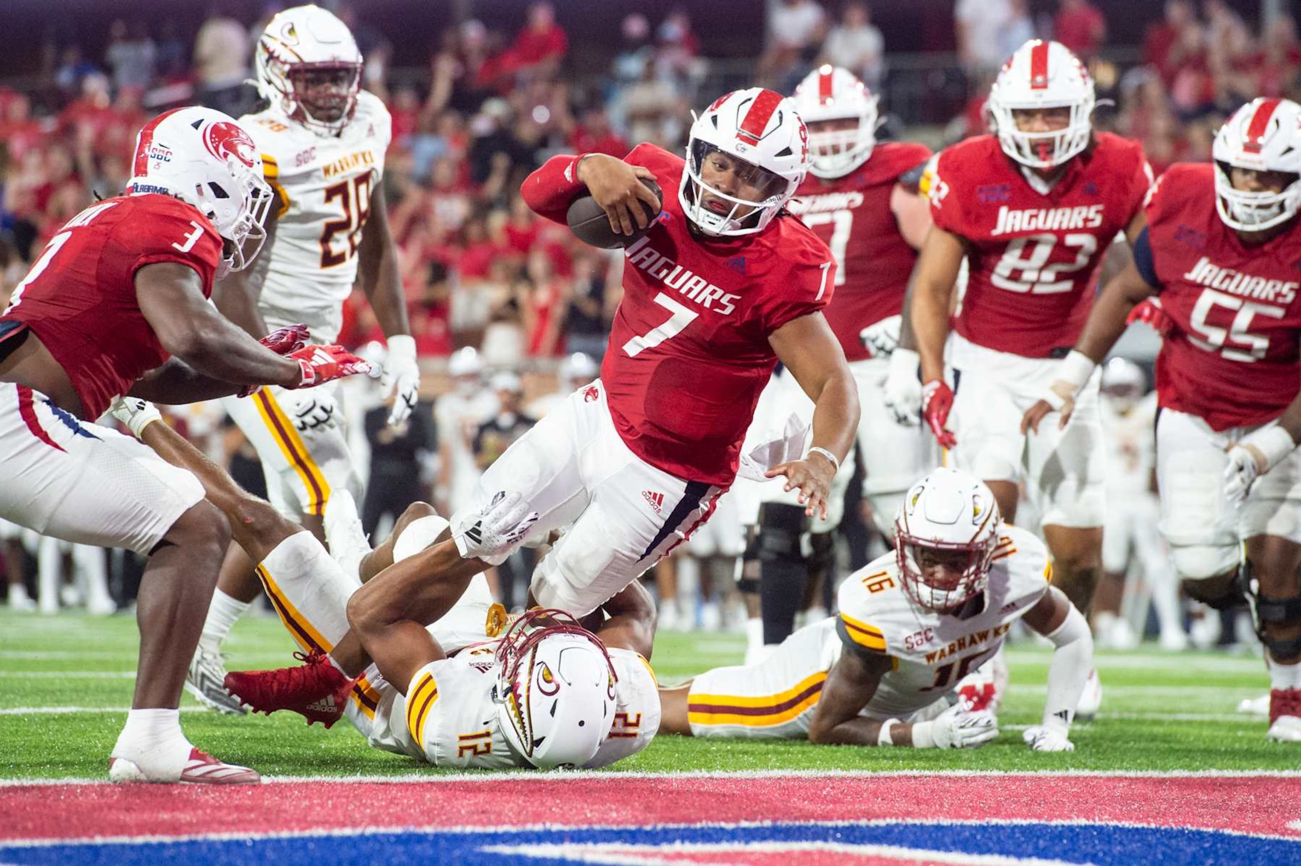MOBILE, ALABAMA - OCTOBER 26: Quarterback Gio Lopez #7 of the South Alabama Jaguars reaches for a touchdown over defensive back Wydett Williams Jr. #12 of the Louisiana Monroe Warhawks during the second half of play at Hancock Whitney Stadium on October 26, 2024 in Mobile, Alabama. (Photo by Michael Chang/Getty Images) MOBILE, ALABAMA - OCTOBER 26: Quarterback Gio Lopez #7 of the South Alabama Jaguars reaches for a touchdown over defensive back Wydett Williams Jr. #12 of the Louisiana Monroe Warhawks during the second half of play at Hancock Whitney Stadium on October 26, 2024 in Mobile, Alabama. (Photo by Michael Chang/Getty Images)