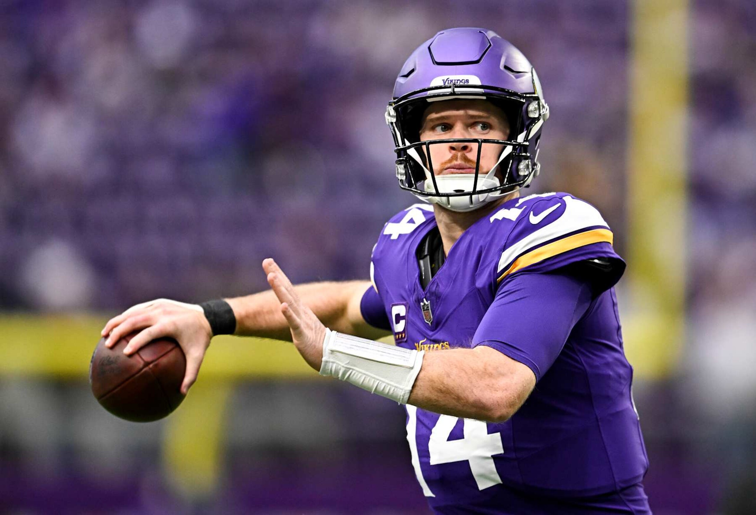 MINNEAPOLIS, MINNESOTA - DECEMBER 8: Quarterback Sam Darnold #14 of the Minnesota Vikings warms up before the game against the Atlanta Falcons at U.S. Bank Stadium on December 8, 2024 in Minneapolis, Minnesota. The Vikings defeated the Falcons 42-21. (Photo by Stephen Maturen/Getty Images)