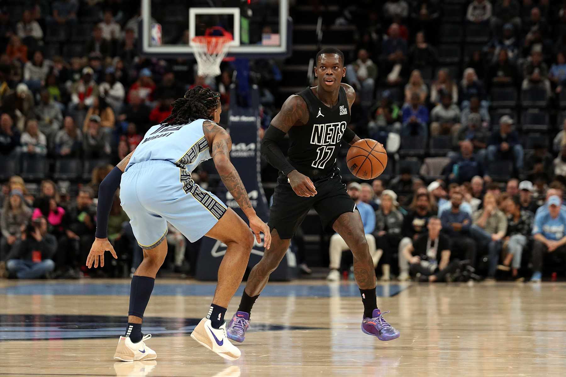 MEMPHIS, TENNESSEE - DECEMBER 13: Dennis Schroder #17 of the Brooklyn Nets handles the ball against Ja Morant #12 of the Memphis Grizzlies during the first half at FedExForum on December 13, 2024 in Memphis, Tennessee. NOTE TO USER: User expressly acknowledges and agrees that, by downloading and or using this photograph, User is consenting to the terms and conditions of the Getty Images License Agreement. (Photo by Justin Ford/Getty Images)