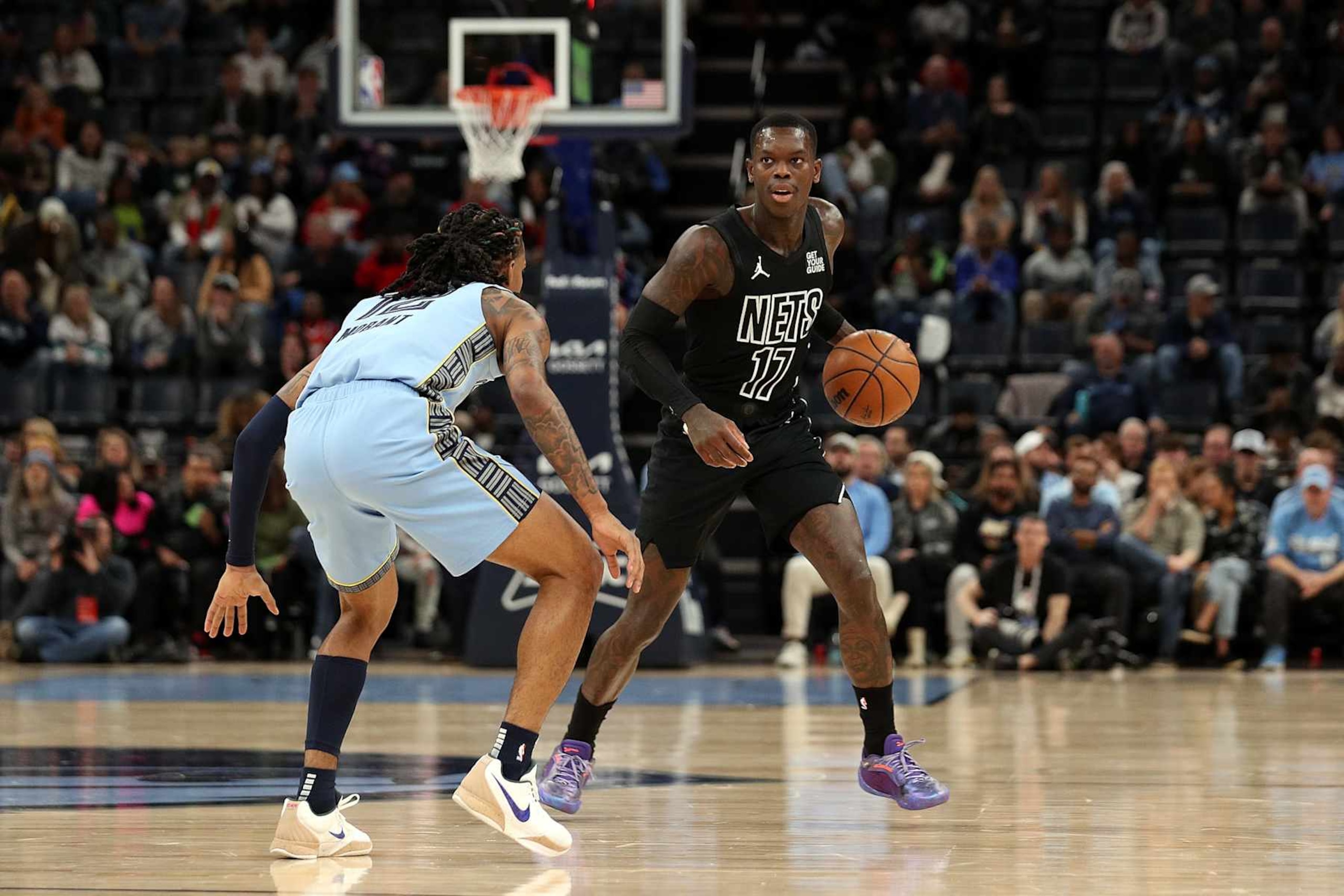 MEMPHIS, TENNESSEE - DECEMBER 13: Dennis Schroder #17 of the Brooklyn Nets handles the ball against Ja Morant #12 of the Memphis Grizzlies during the first half at FedExForum on December 13, 2024 in Memphis, Tennessee. NOTE TO USER: User expressly acknowledges and agrees that, by downloading and or using this photograph, User is consenting to the terms and conditions of the Getty Images License Agreement. (Photo by Justin Ford/Getty Images)