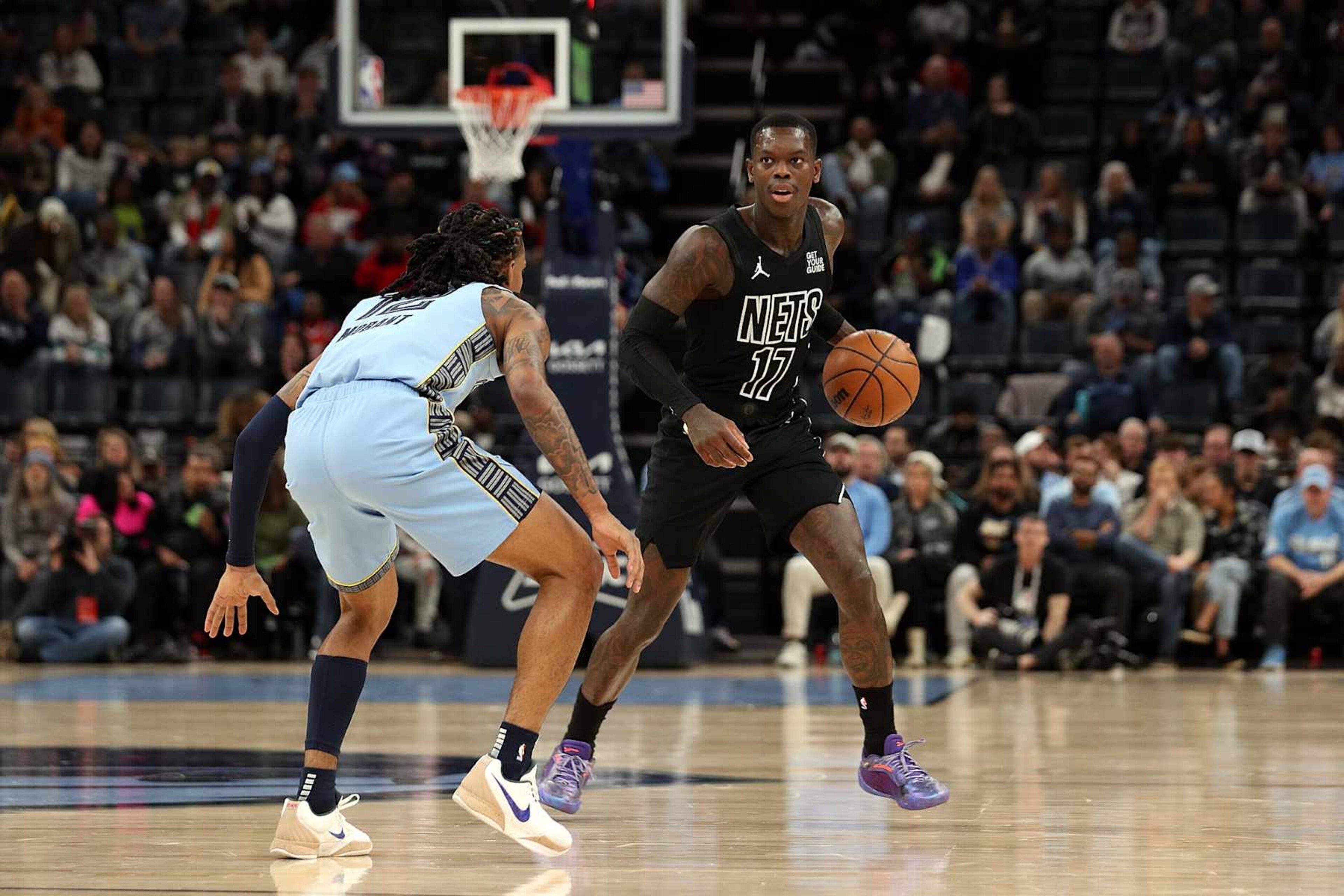 MEMPHIS, TENNESSEE - DECEMBER 13: Dennis Schroder #17 of the Brooklyn Nets handles the ball against Ja Morant #12 of the Memphis Grizzlies during the first half at FedExForum on December 13, 2024 in Memphis, Tennessee. NOTE TO USER: User expressly acknowledges and agrees that, by downloading and or using this photograph, User is consenting to the terms and conditions of the Getty Images License Agreement. (Photo by Justin Ford/Getty Images)