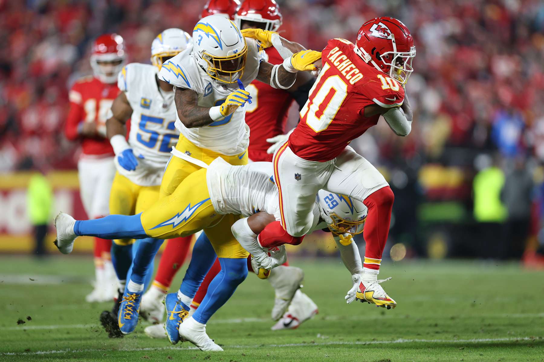 KANSAS CITY, MISSOURI - DECEMBER 08: Isiah Pacheco #10 of the Kansas City Chiefs is tackled by Tarheeb Still #29 of the Los Angeles Chargers during the fourth quarter at GEHA Field at Arrowhead Stadium on December 08, 2024 in Kansas City, Missouri. (Photo by Jamie Squire/Getty Images)