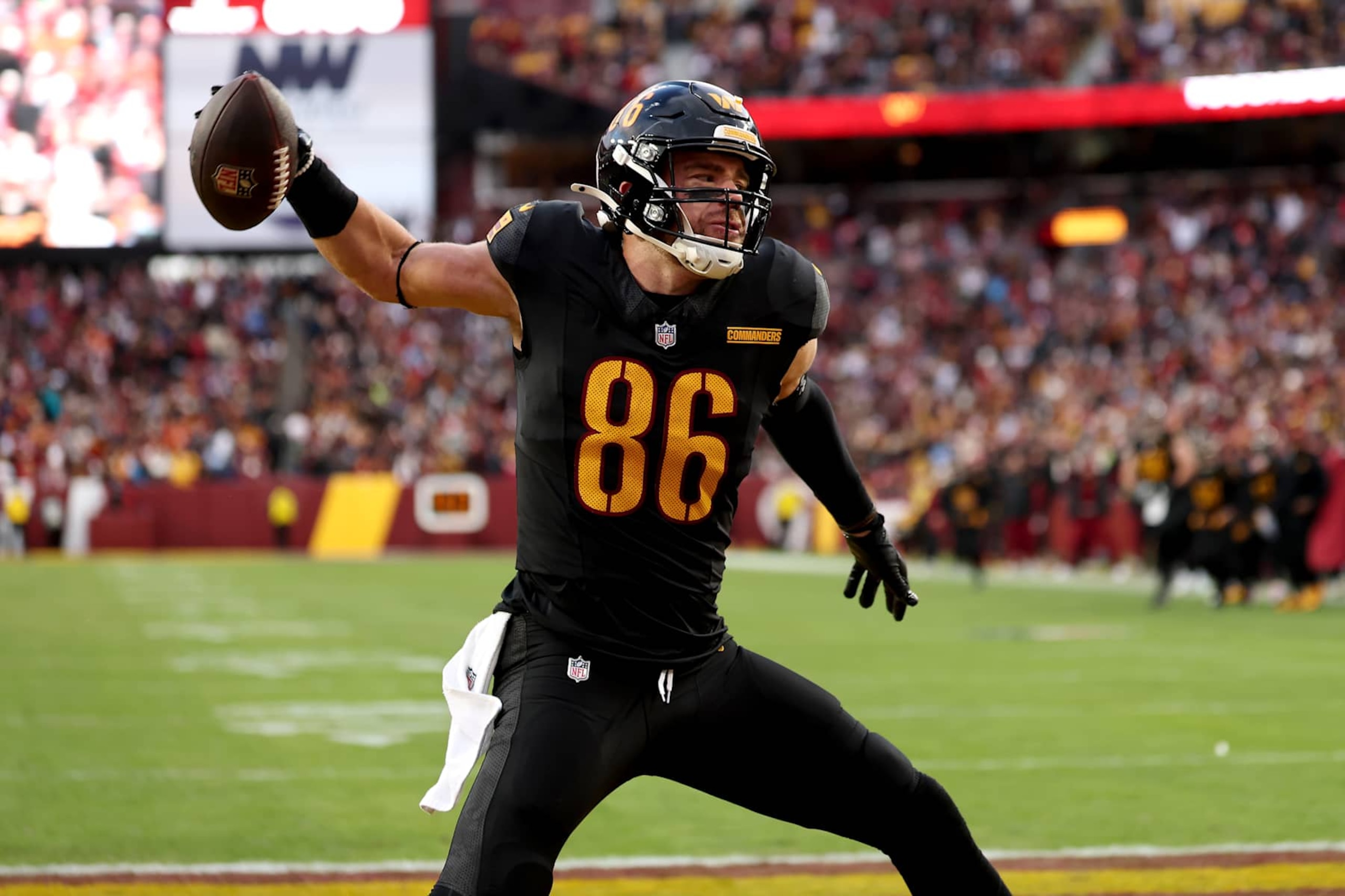 LANDOVER, MARYLAND - DECEMBER 01: Zach Ertz #86 of the Washington Commanders celebrates after catching a touchdown pass in the fourth quarter of a game against the Tennessee Titans at Northwest Stadium on December 01, 2024 in Landover, Maryland. (Photo by Scott Taetsch/Getty Images)
