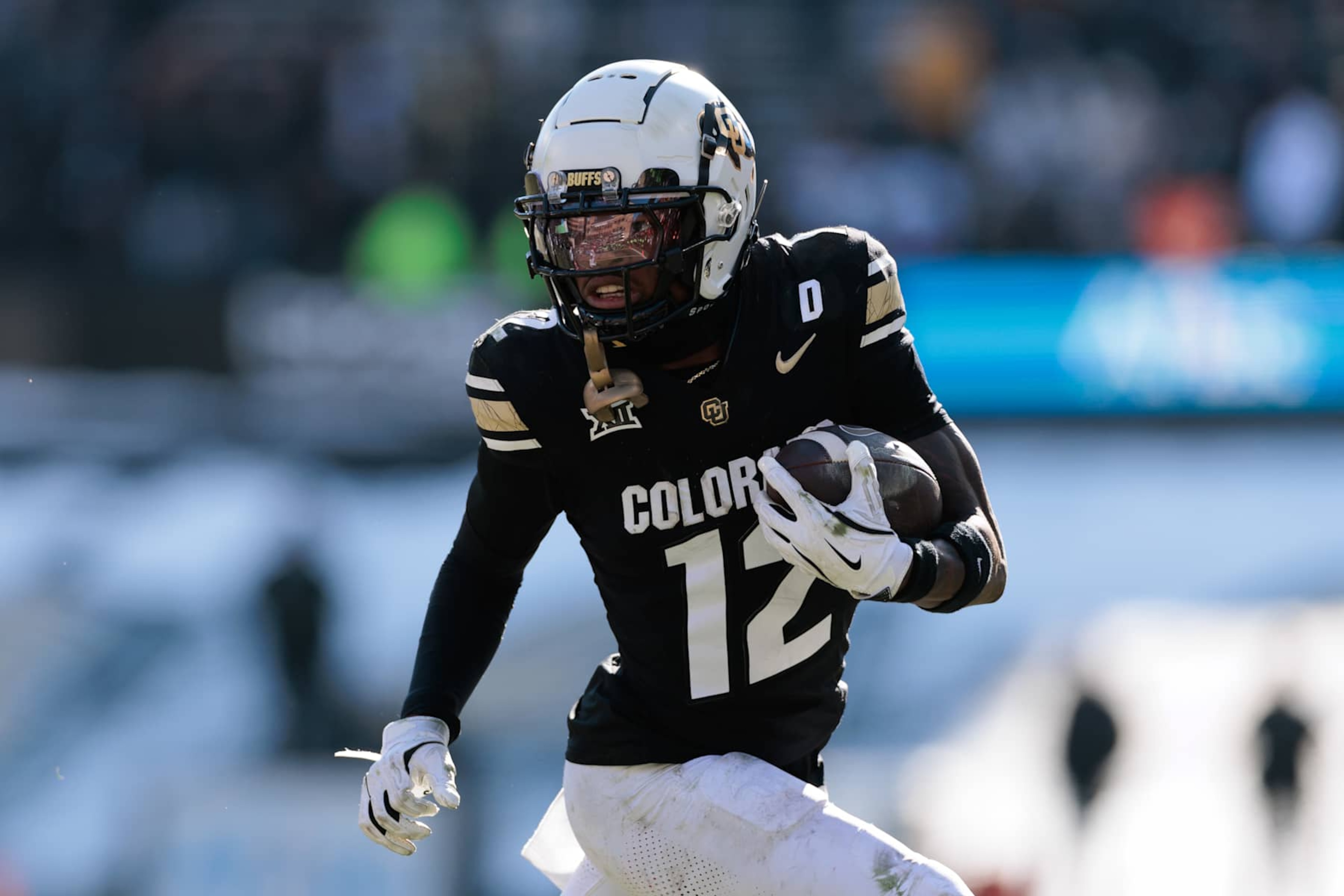 BOULDER, COLORADO - NOVEMBER 29: Travis Hunter #12 of the Colorado Buffaloes runs with the ball during the third quarter against the Oklahoma State Cowboys at Folsom Field on November 29, 2024 in Boulder, Colorado. (Photo by Andrew Wevers/Getty Images)