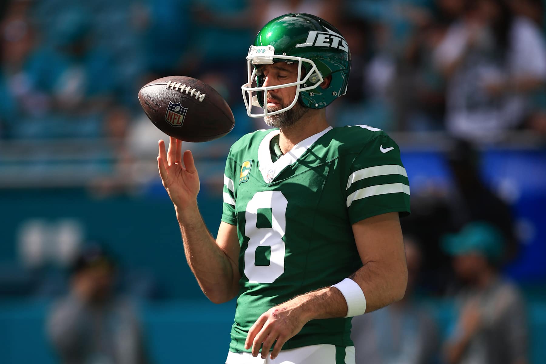 MIAMI GARDENS, FLORIDA - DECEMBER 08: Aaron Rodgers #8 of the New York Jets spins a football prior to a game against the Miami Dolphins at Hard Rock Stadium on December 08, 2024 in Miami Gardens, Florida. (Photo by Megan Briggs/Getty Images)