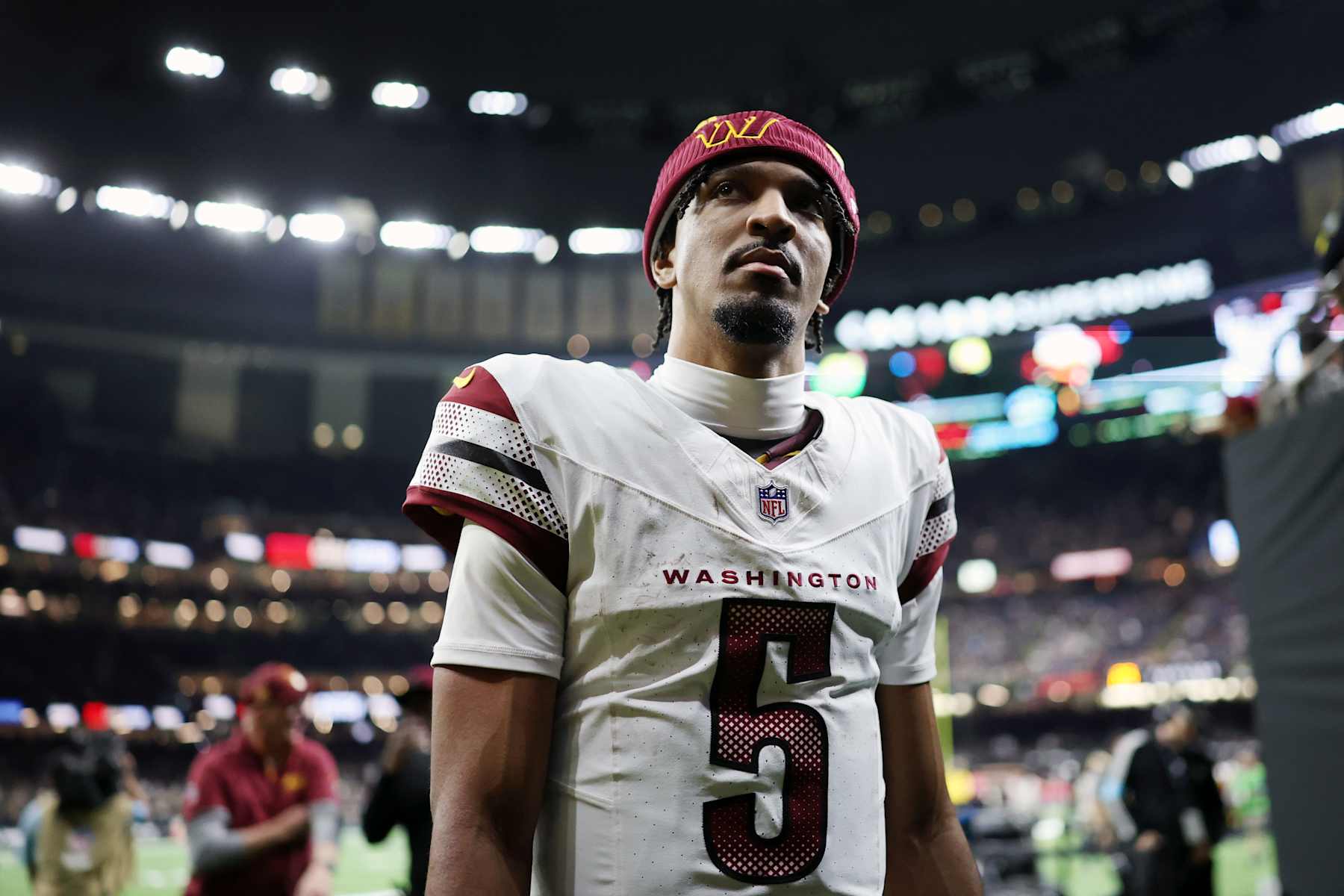 NEW ORLEANS, LOUISIANA - DECEMBER 15: Jayden Daniels #5 of the Washington Commanders walks off the field after the second quarter of a game against the New Orleans Saints at Caesars Superdome on December 15, 2024 in New Orleans, Louisiana. (Photo by Chris Graythen/Getty Images)