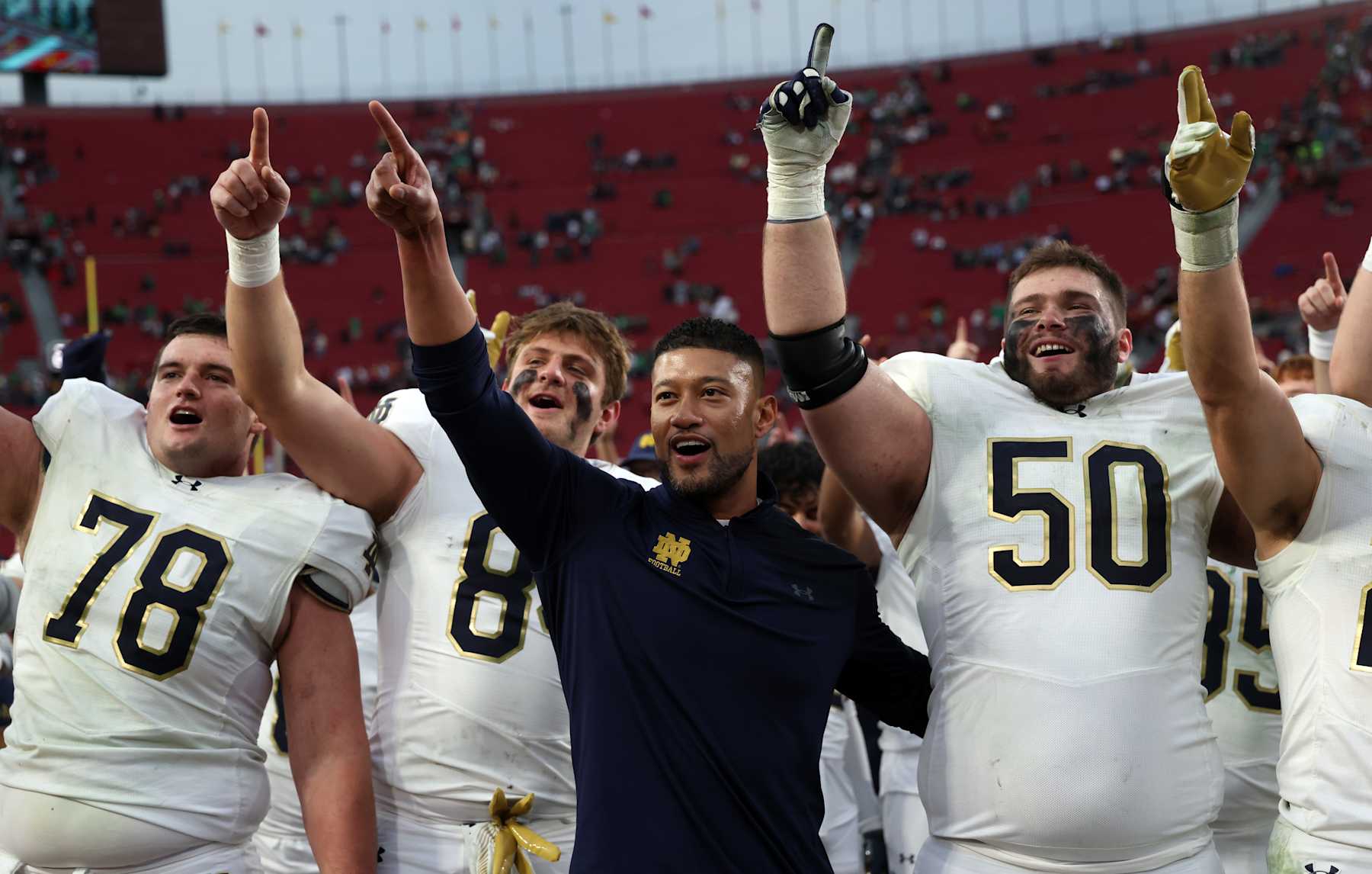 LOS ANGELES, CALIFORNIA - NOVEMBER 30: Head coach Marcus Freeman of the Notre Dame Fighting Irish celebrates with his players after defeating the USC Trojans 49-35 at United Airlines Field at the Los Angeles Memorial Coliseum on November 30, 2024 in Los Angeles, California. (Photo by Kevork Djansezian/Getty Images)