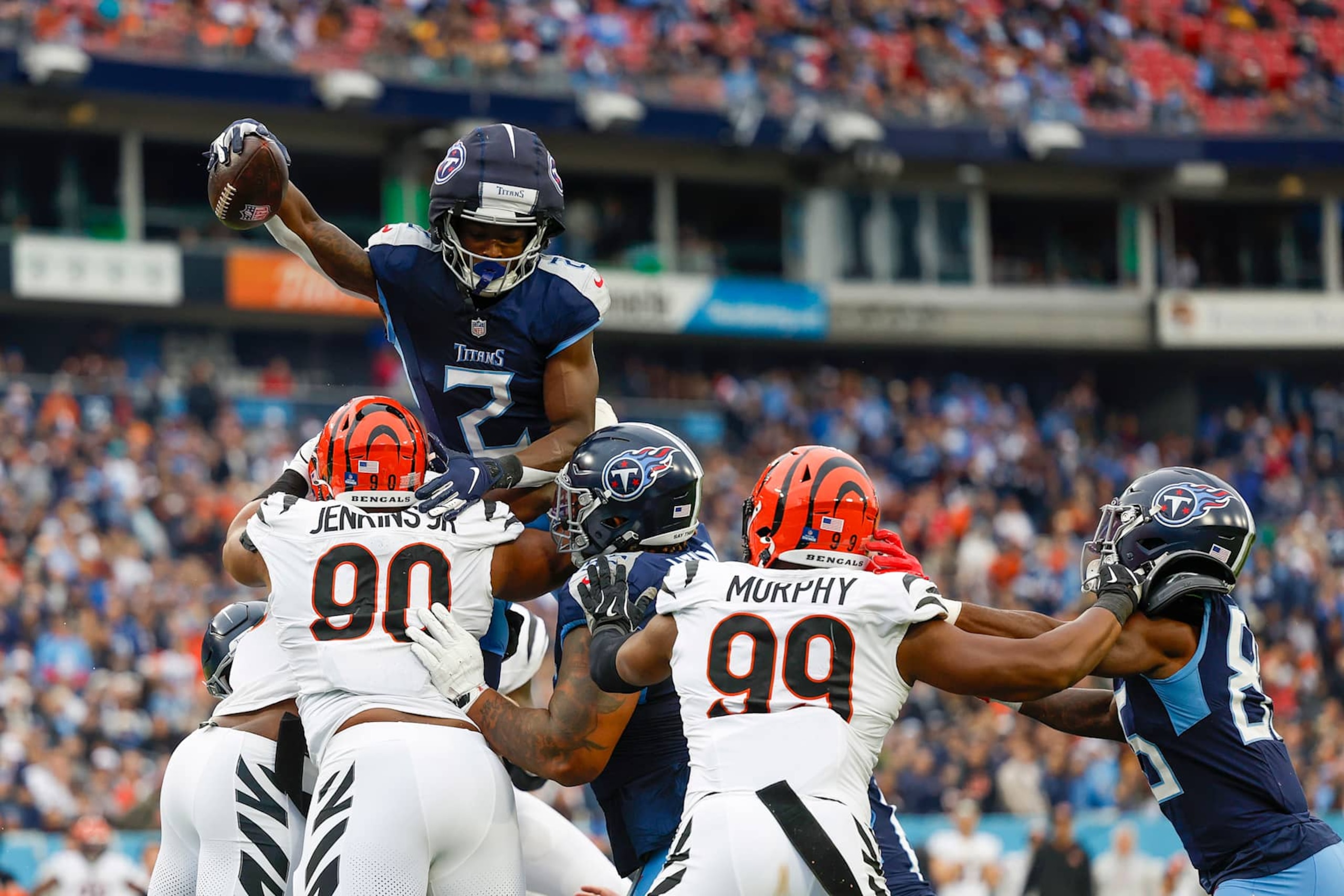 NASHVILLE, TENNESSEE - DECEMBER 15: Tyjae Spears #2 of the Tennessee Titans scores a rushing touchdown over Kris Jenkins Jr. #90 of the Cincinnati Bengals in the first quarter of a game at Nissan Stadium on December 15, 2024 in Nashville, Tennessee. (Photo by Wesley Hitt/Getty Images) NASHVILLE, TENNESSEE - DECEMBER 15: Tyjae Spears #2 of the Tennessee Titans scores a rushing touchdown over Kris Jenkins Jr. #90 of the Cincinnati Bengals in the first quarter of a game at Nissan Stadium on December 15, 2024 in Nashville, Tennessee. (Photo by Wesley Hitt/Getty Images)