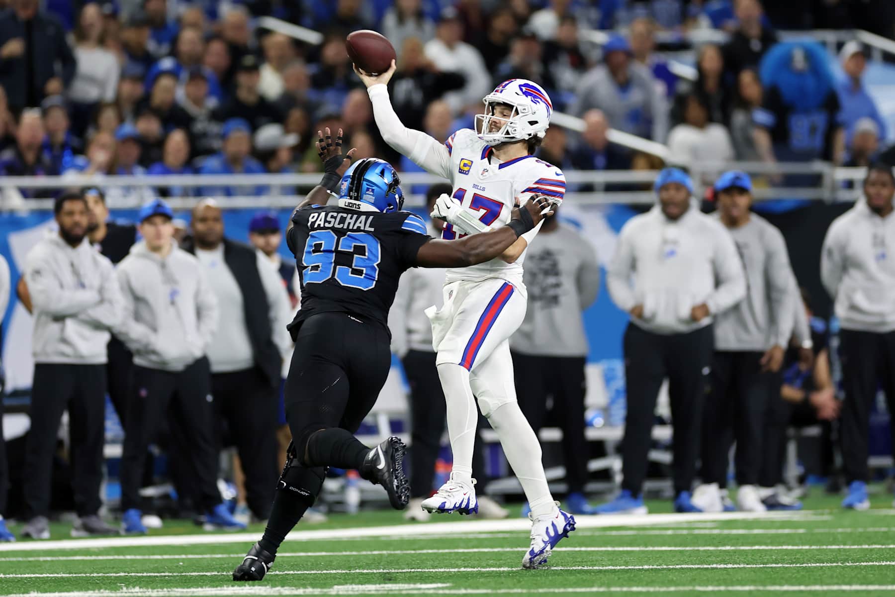 DETROIT, MICHIGAN - DECEMBER 15: Josh Allen #17 of the Buffalo Bills throws a pass while being pressured by Josh Paschal #93 of the Detroit Lions in the first quarter at Ford Field on December 15, 2024 in Detroit, Michigan. (Photo by Mike Mulholland/Getty Images)