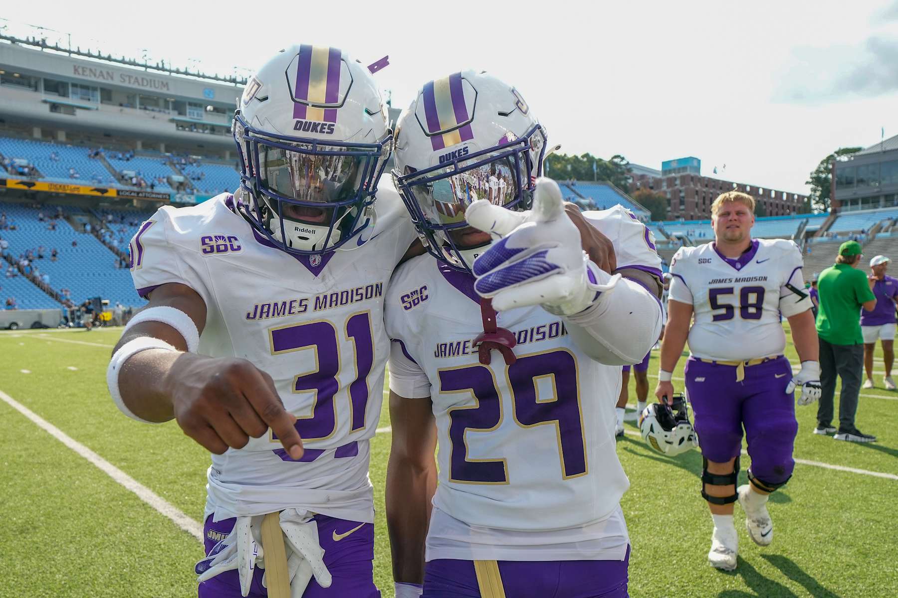 CHAPEL HILL, NORTH CAROLINA - SEPTEMBER 21: Antoine Booth #31 and Tyler Brown #29 of the James Madison Dukes celebrate as they leave the field after a win against the North Carolina Tar Heels at Kenan Memorial Stadium on September 21, 2024 in Chapel Hill, North Carolina. The Dukes won 70-50. (Photo by Grant Halverson/Getty Images)