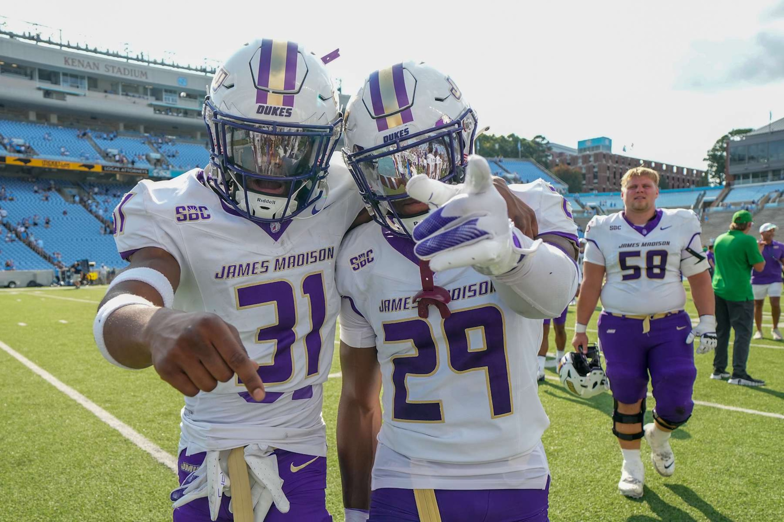 CHAPEL HILL, NORTH CAROLINA - SEPTEMBER 21: Antoine Booth #31 and Tyler Brown #29 of the James Madison Dukes celebrate as they leave the field after a win against the North Carolina Tar Heels at Kenan Memorial Stadium on September 21, 2024 in Chapel Hill, North Carolina. The Dukes won 70-50. (Photo by Grant Halverson/Getty Images)