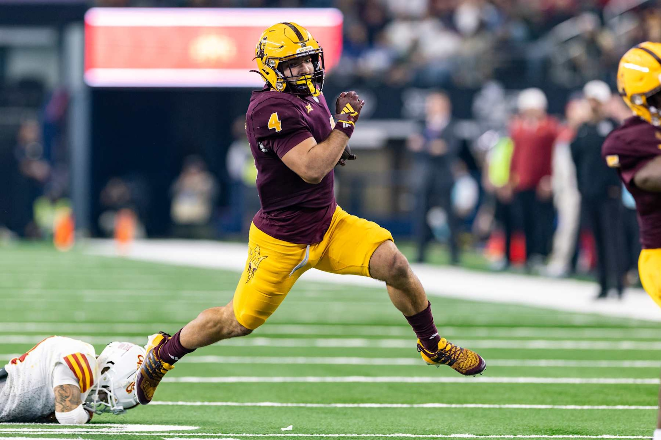 ARLINGTON, TX - DECEMBER 07: Arizona State Sun Devils running back Cam Skattebo (#4) runs up field during the Big 12 championship football game between the Arizona State Sun Devils and the Iowa State Cyclones on December 7, 2024 at AT&T Stadium in Arlington, TX. (Photo by Matthew Visinsky/Icon Sportswire via Getty Images) ARLINGTON, TX - DECEMBER 07: Arizona State Sun Devils running back Cam Skattebo (#4) runs up field during the Big 12 championship football game between the Arizona State Sun Devils and the Iowa State Cyclones on December 7, 2024 at AT&T Stadium in Arlington, TX. (Photo by Matthew Visinsky/Icon Sportswire via Getty Images)