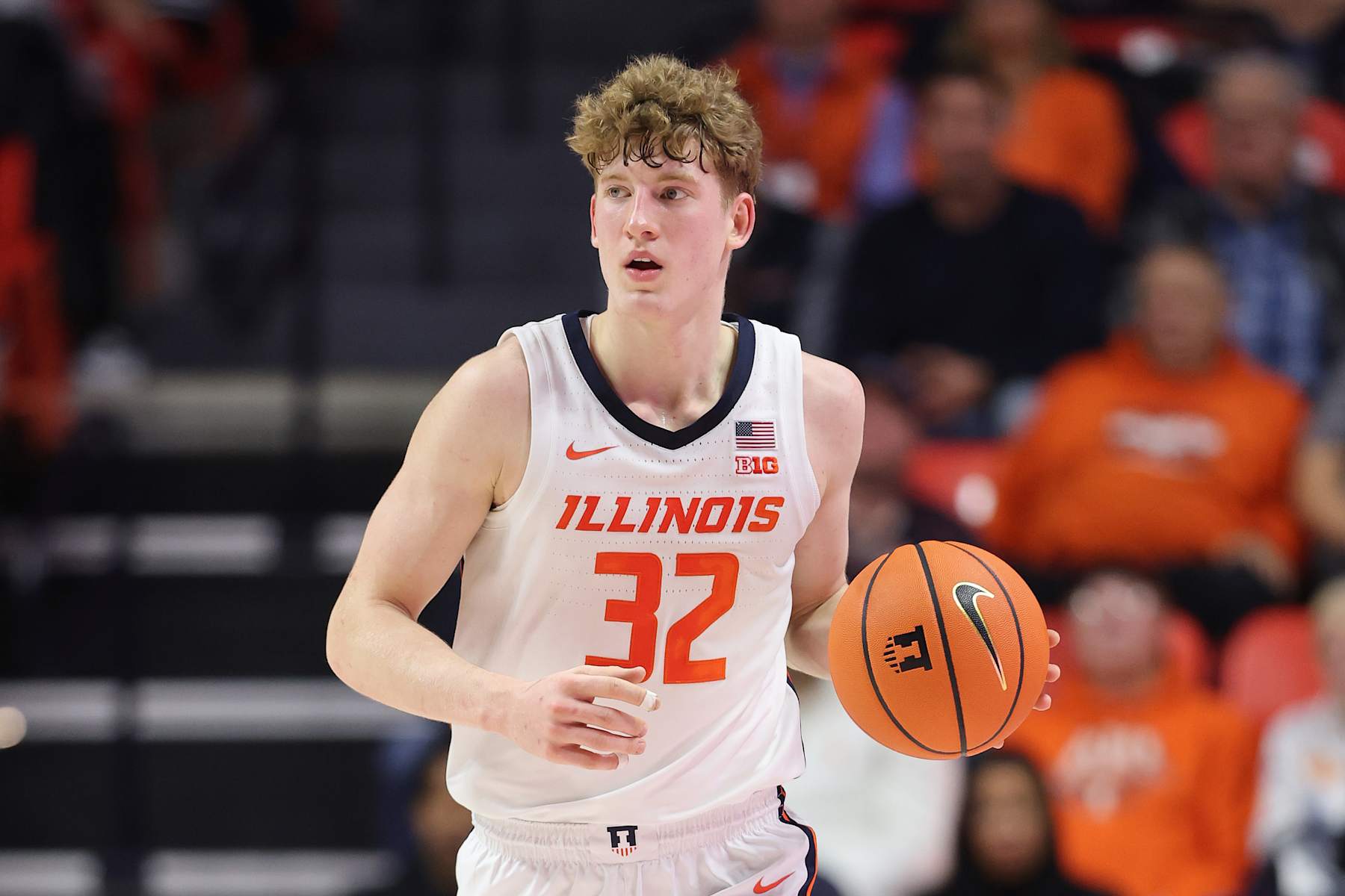 CHAMPAIGN, ILLINOIS - DECEMBER 10: Kasparas Jakucionis #32 of the Illinois Fighting Illini dribbles up the court against the Wisconsin Badgers during the first half at State Farm Center on December 10, 2024 in Champaign, Illinois. (Photo by Michael Reaves/Getty Images)