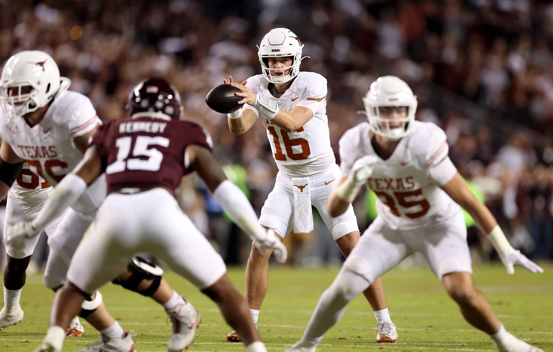 COLLEGE STATION, TEXAS - NOVEMBER 30: Arch Manning #16 of the Texas Longhorns takes a snap in the first half against the Texas A&M Aggies at Kyle Field on November 30, 2024 in College Station, Texas. (Photo by Tim Warner/Getty Images)