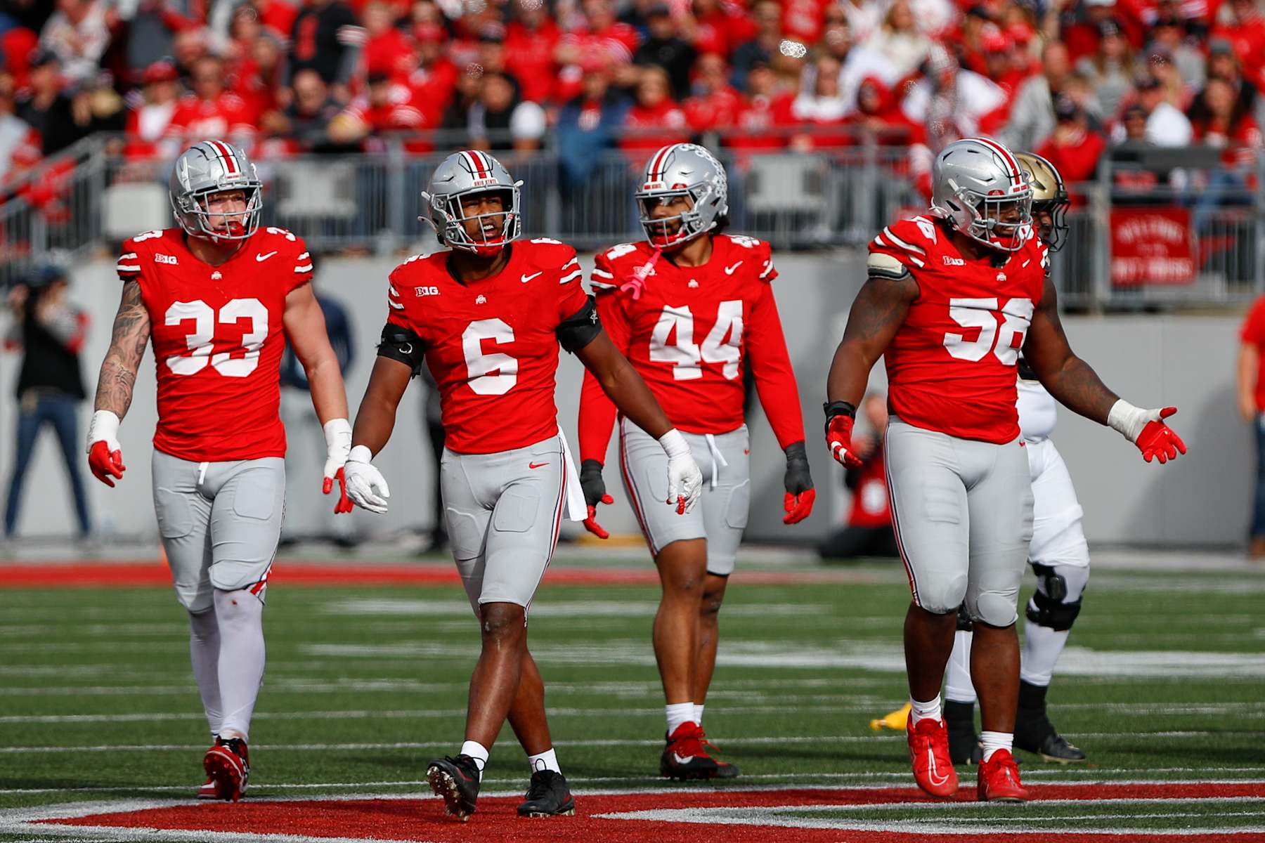 COLUMBUS, OH - NOVEMBER 09: Ohio State Buckeyes defensive end Jack Sawyer (33) stands with safety Sonny Styles (6), defensive end JT Tuimoloau (44) and defensive tackle Ty Hamilton (58) during the game against the Purdue Boilermakers and the Ohio State Buckeyes on November 9, 2024, at Ohio Stadium in Columbus, OH. (Photo by Ian Johnson/Icon Sportswire via Getty Images)