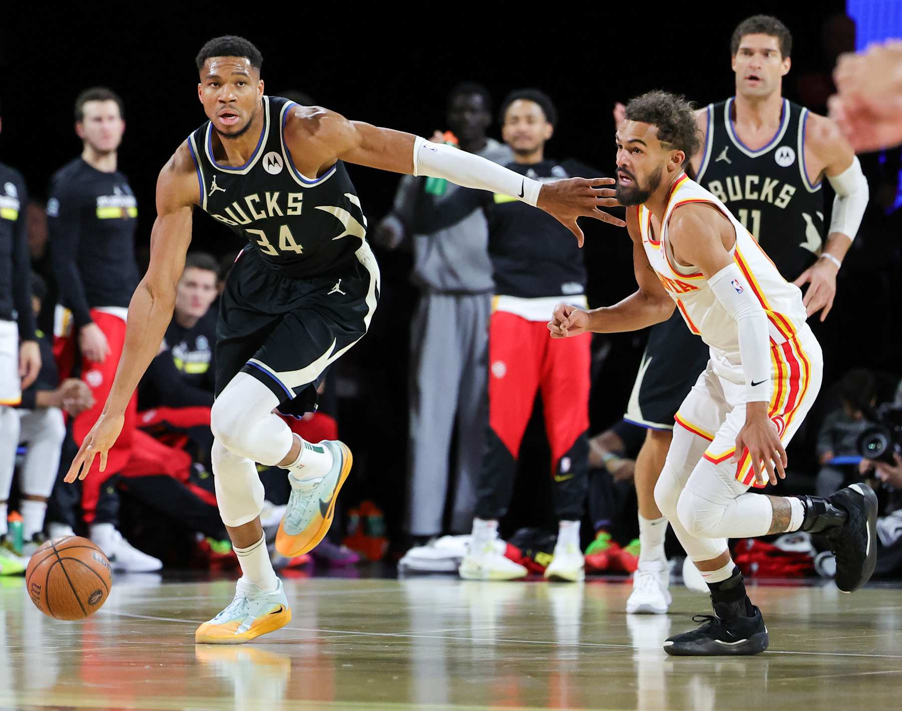 LAS VEGAS, NEVADA - DECEMBER 14: Giannis Antetokounmpo #34 of the Milwaukee Bucks brings the ball up the court against Trae Young #11 of the Atlanta Hawks in the first half of a semifinal game of the Emirates NBA Cup at T-Mobile Arena on December 14, 2024 in Las Vegas, Nevada. The Bucks defeated the Hawks 110-102. NOTE TO USER: User expressly acknowledges and agrees that, by downloading and or using this photograph, User is consenting to the terms and conditions of the Getty Images License Agreement. (Photo by Ethan Miller/Getty Images)