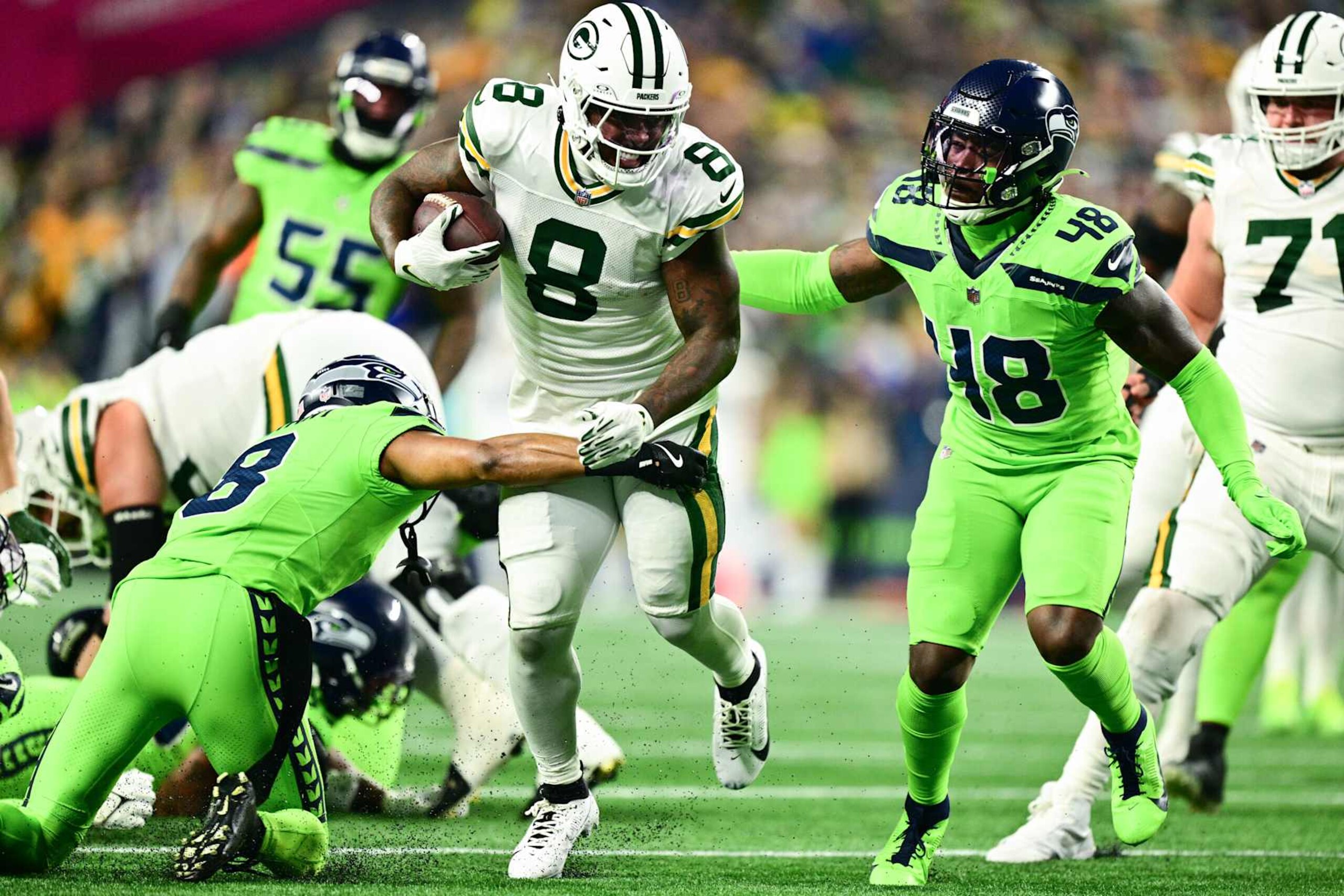 SEATTLE, WASHINGTON - DECEMBER 15: Josh Jacobs #8 of the Green Bay Packers carries the ball against the Seattle Seahawks during the first quarter of the game at Lumen Field on December 15, 2024 in Seattle, Washington. (Photo by Jane Gershovich/Getty Images)