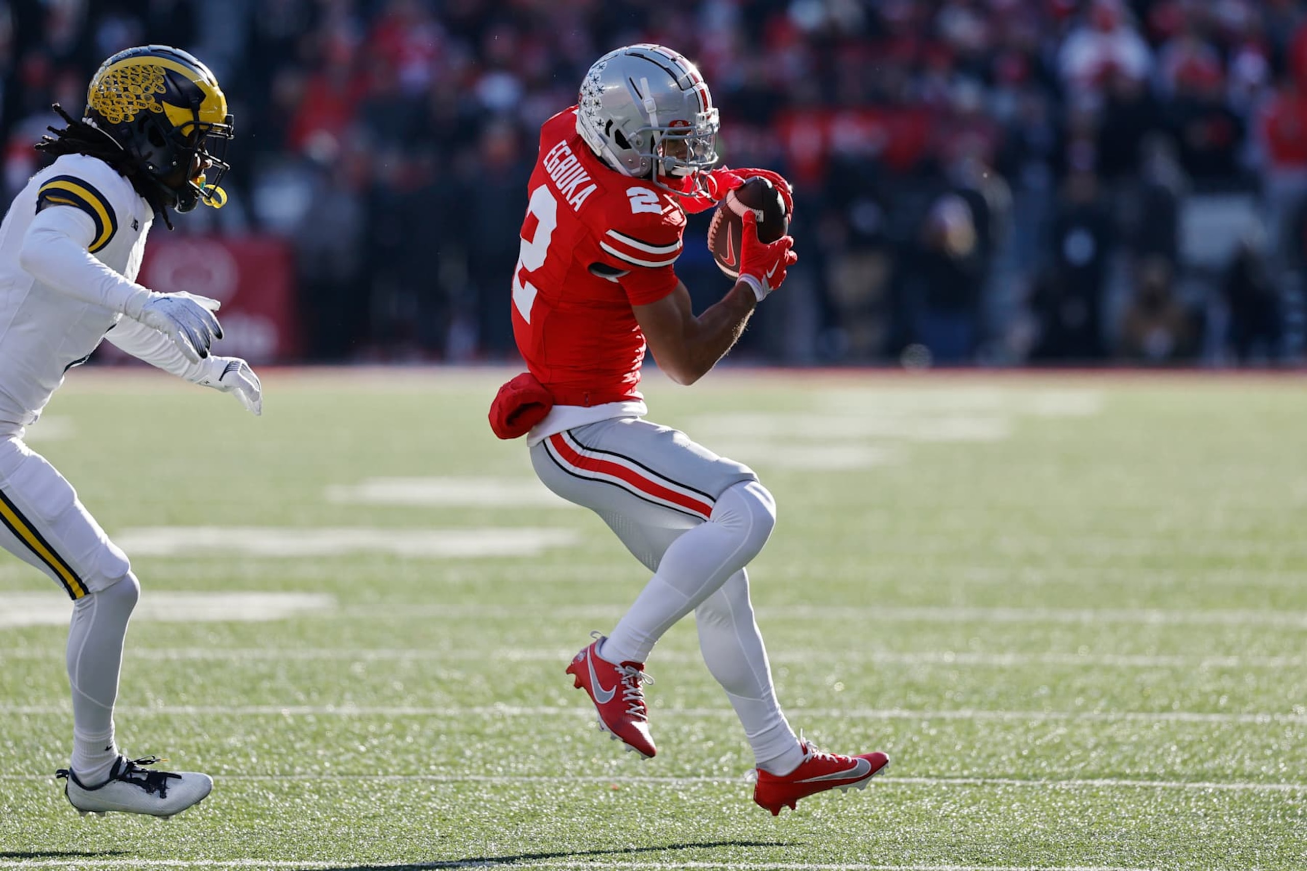 COLUMBUS, OH - NOVEMBER 30: Ohio State Buckeyes wide receiver Emeka Egbuka (2) makes a reception while defended by Michigan Wolverines defensive back Makari Paige (7) during a college football game on November 30, 2024 at Ohio Stadium in Columbus, Ohio. (Photo by Joe Robbins/Icon Sportswire via Getty Images)