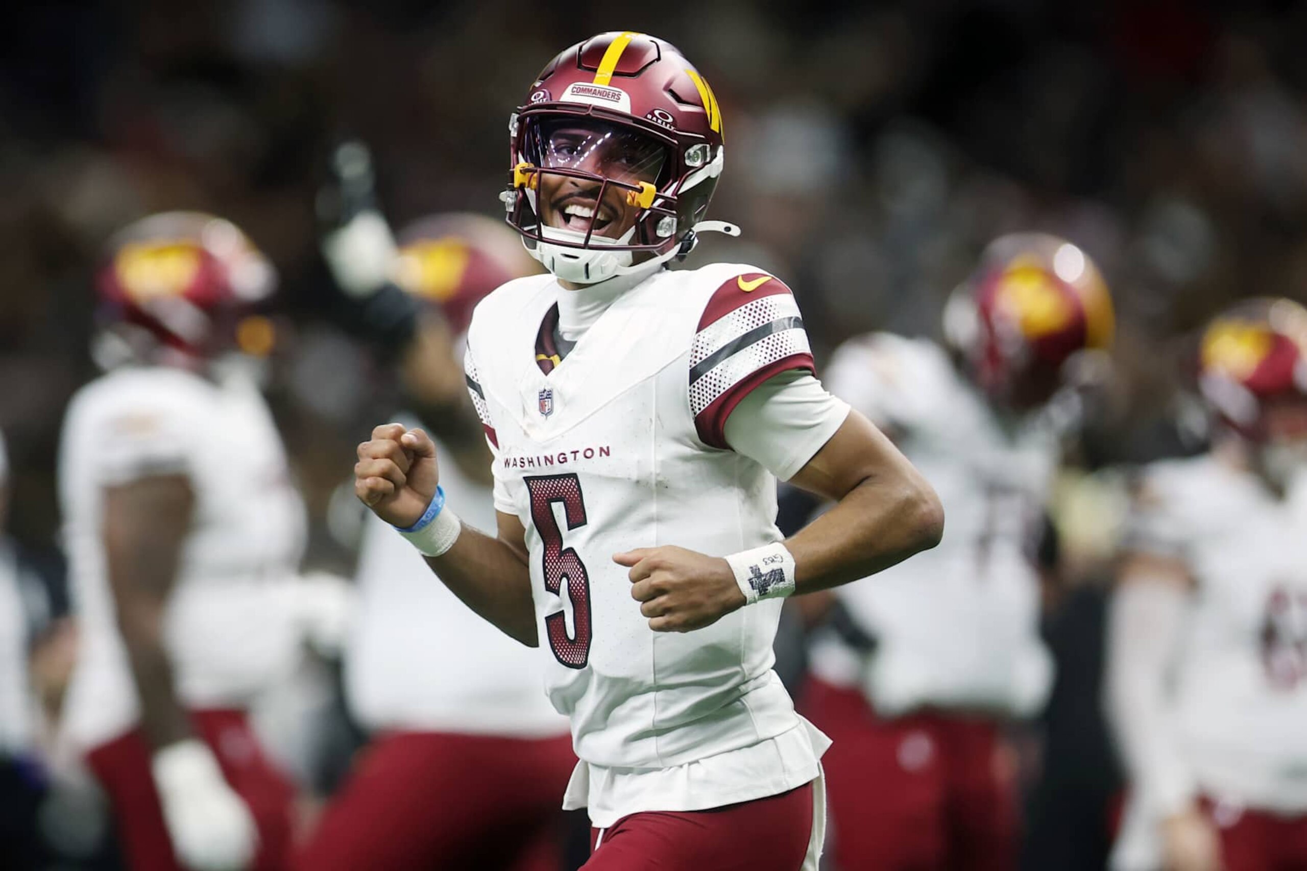 NEW ORLEANS, LOUISIANA - DECEMBER 15: Jayden Daniels #5 of the Washington Commanders celebrates after throwing a pass for a touchdown during the second quarter against the New Orleans Saints] at Caesars Superdome on December 15, 2024 in New Orleans, Louisiana. (Photo by Chris Graythen/Getty Images)