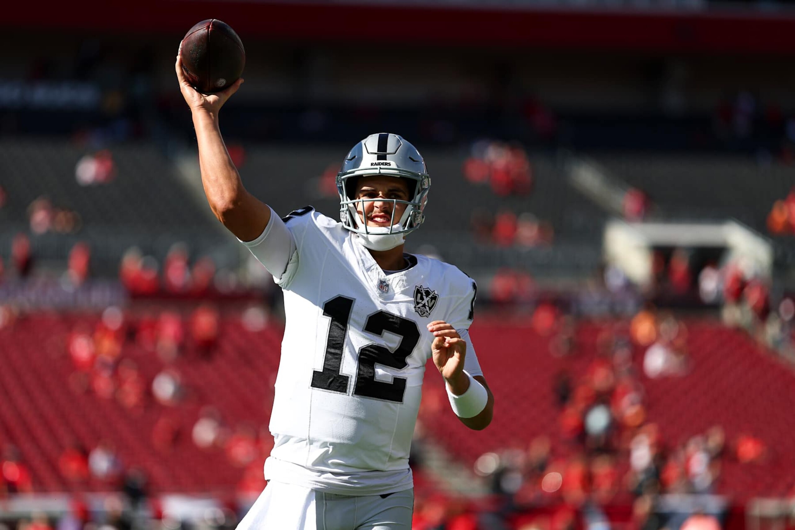 TAMPA, FLORIDA - DECEMBER 8: Aidan O'Connell #12 of the Las Vegas Raiders warms up prior to an NFL football game against the Tampa Bay Buccaneers at Raymond James Stadium on December 8, 2024 in Tampa, Florida. (Photo by Kevin Sabitus/Getty Images)