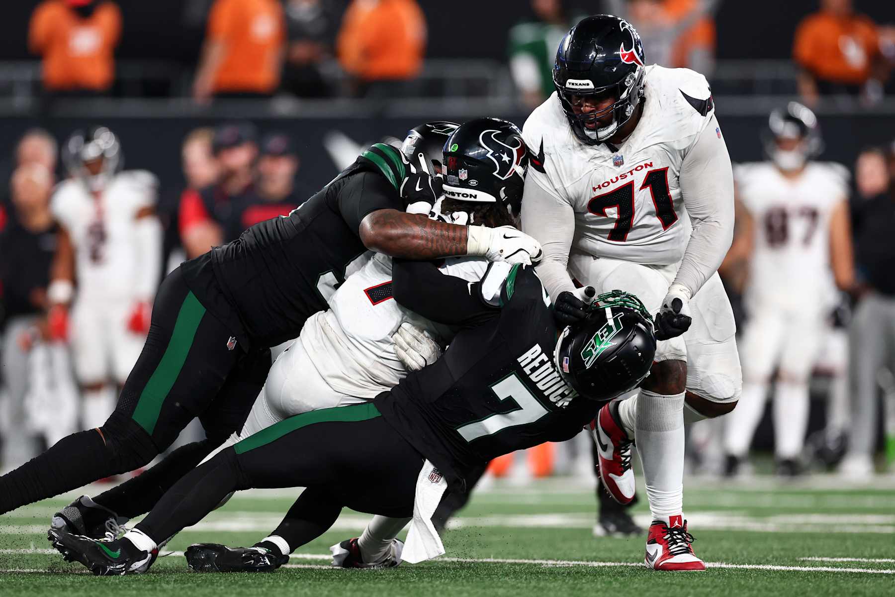 EAST RUTHERFORD, NEW JERSEY - OCTOBER 31: Haason Reddick #7 and Quinnen Williams #95 of the New York Jets sack C.J. Stroud #7 of the Houston Texans during the second half of an NFL football game, at MetLife Stadium on October 31, 2024 in East Rutherford, New Jersey. (Photo by Kevin Sabitus/Getty Images)