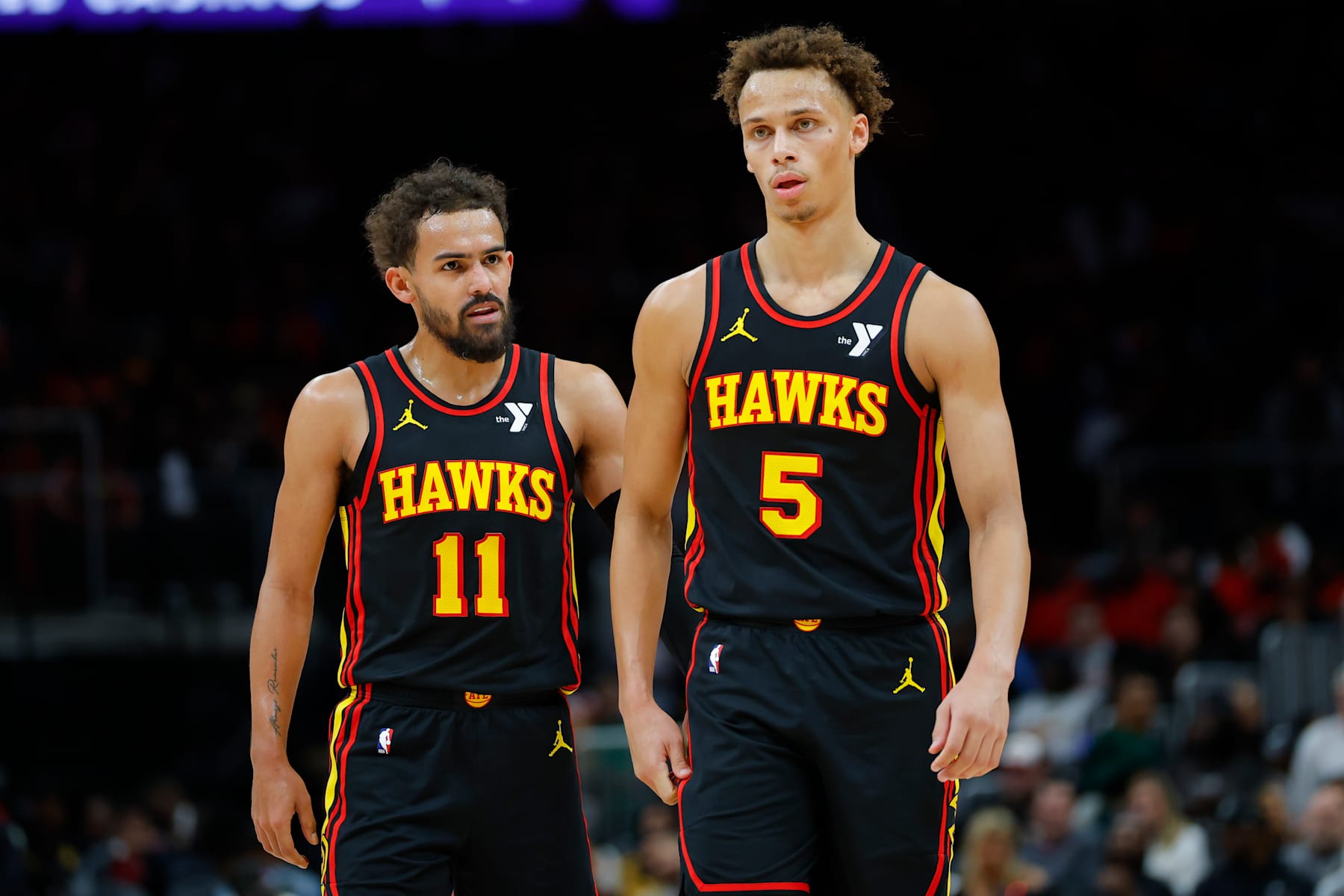 ATLANTA, GEORGIA - DECEMBER 08: Trae Young #11 speaks with Dyson Daniels #5 of the Atlanta Hawks during the second quarter against the Denver Nuggets at State Farm Arena on December 8, 2024 in Atlanta, Georgia. NOTE TO USER: User expressly acknowledges and agrees that, by downloading and or using this photograph, User is consenting to the terms and conditions of the Getty Images License Agreement. (Photo by Todd Kirkland/Getty Images)