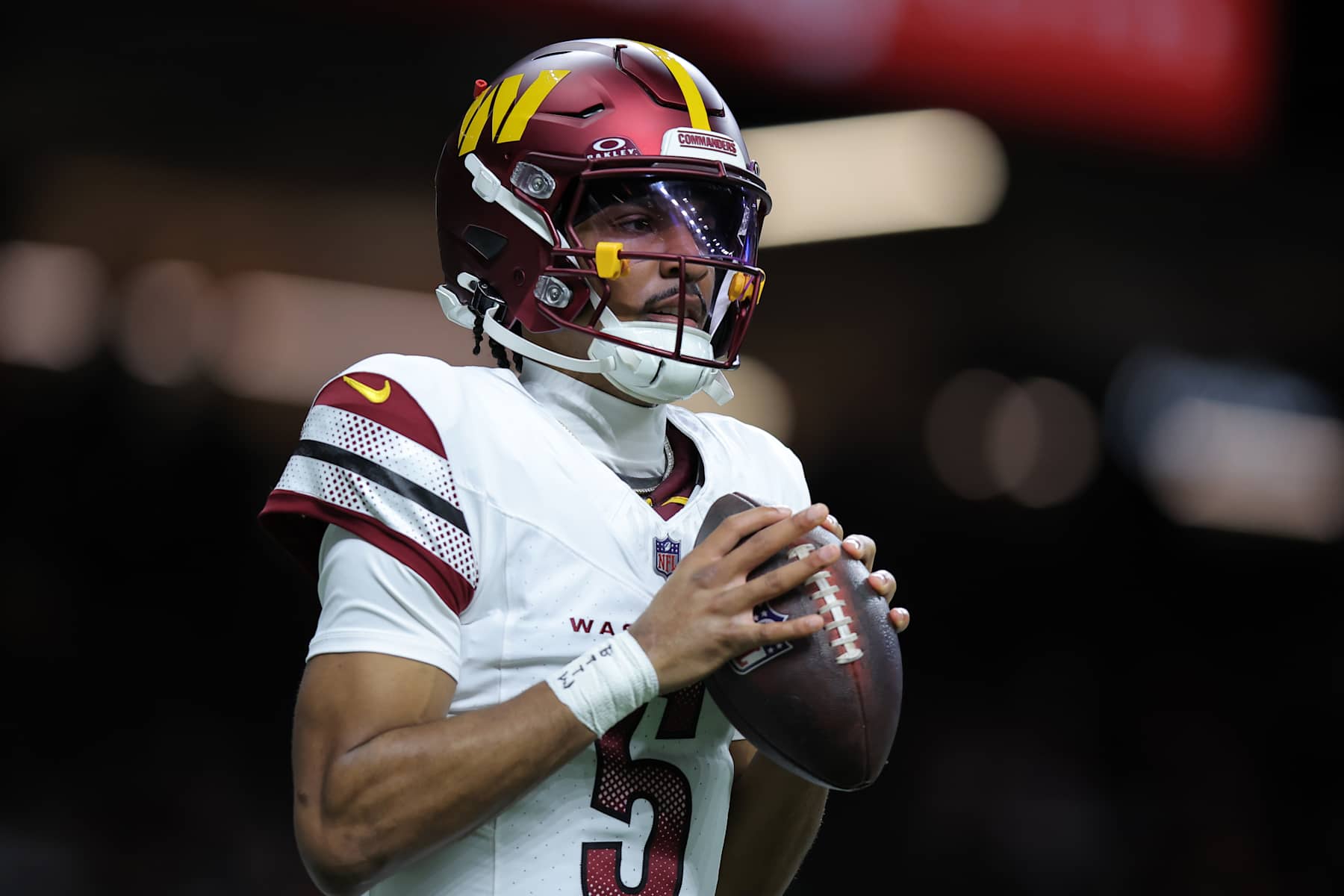 NEW ORLEANS, LOUISIANA - DECEMBER 15: Jayden Daniels #5 of the Washington Commanders reacts against the New Orleans Saints during a game at Caesars Superdome on December 15, 2024 in New Orleans, Louisiana. (Photo by Jonathan Bachman/Getty Images)