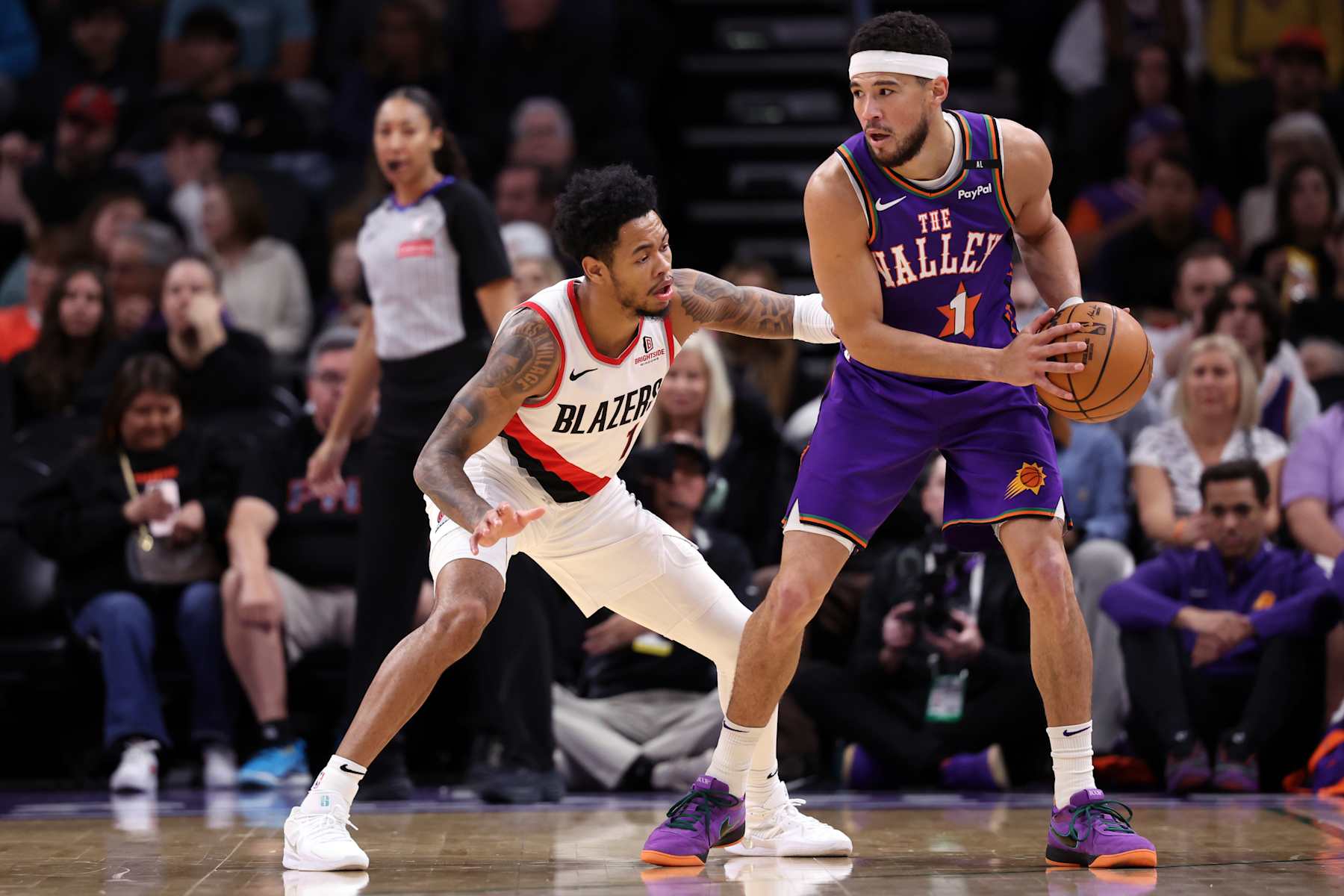 PHOENIX, ARIZONA - DECEMBER 15: Devin Booker #1 of the Phoenix Suns posts up on Anfernee Simons #1 of the Portland Trail Blazers during the game at Footprint Center on December 15, 2024 in Phoenix, Arizona. The Suns defeated the Blazers 116-109. NOTE TO USER: User expressly acknowledges and agrees that, by downloading and or using this photograph, User is consenting to the terms and conditions of the Getty Images License Agreement.  (Photo by Chris Coduto/Getty Images)