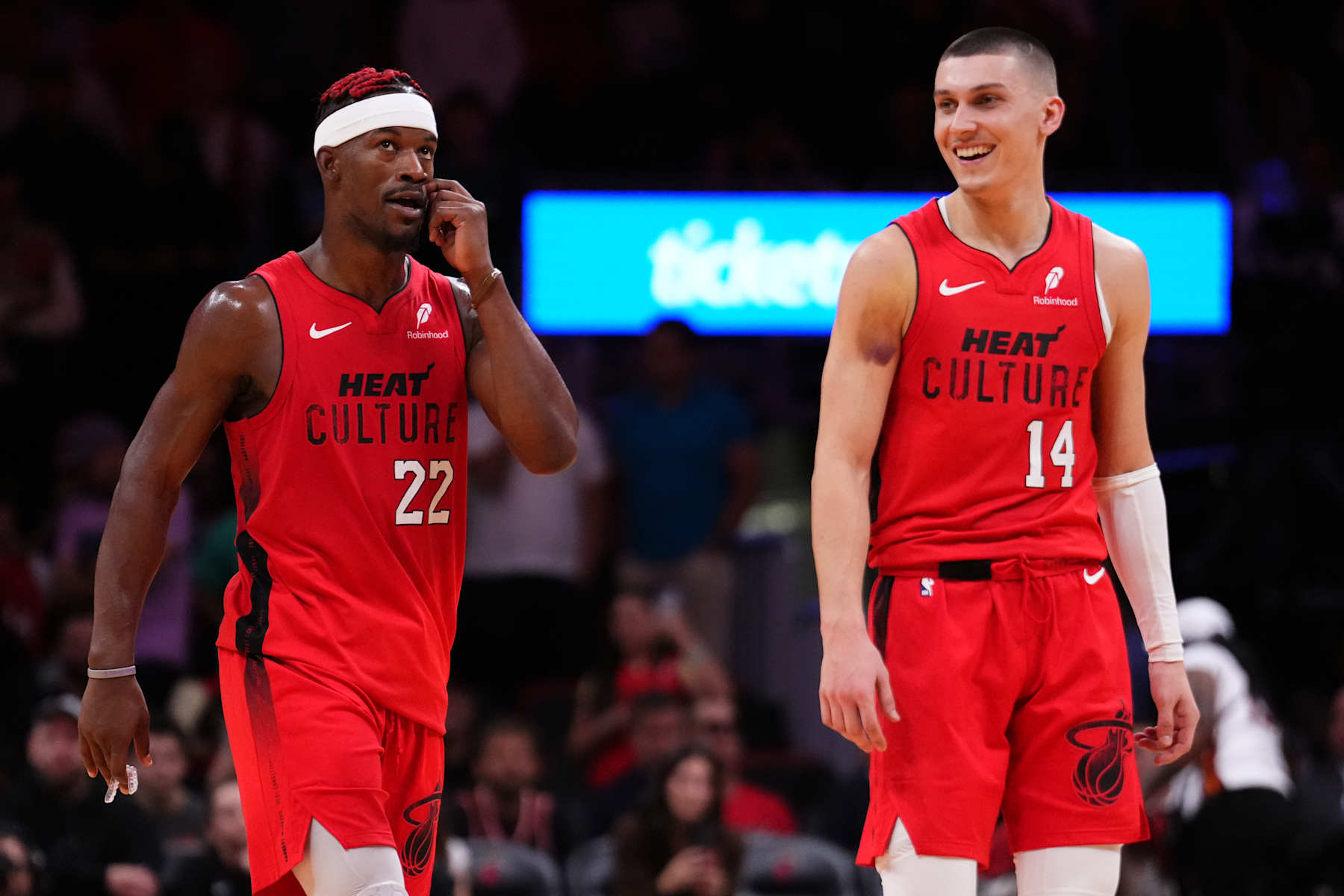 MIAMI, FLORIDA - NOVEMBER 24: Jimmy Butler #22 and Tyler Herro #14 of the Miami Heat react against the Dallas Mavericks during overtime at Kaseya Center on November 24, 2024 in Miami, Florida. NOTE TO USER: User expressly acknowledges and agrees that, by downloading and or using this photograph, User is consenting to the terms and conditions of the Getty Images License Agreement. (Photo by Rich Storry/Getty Images)