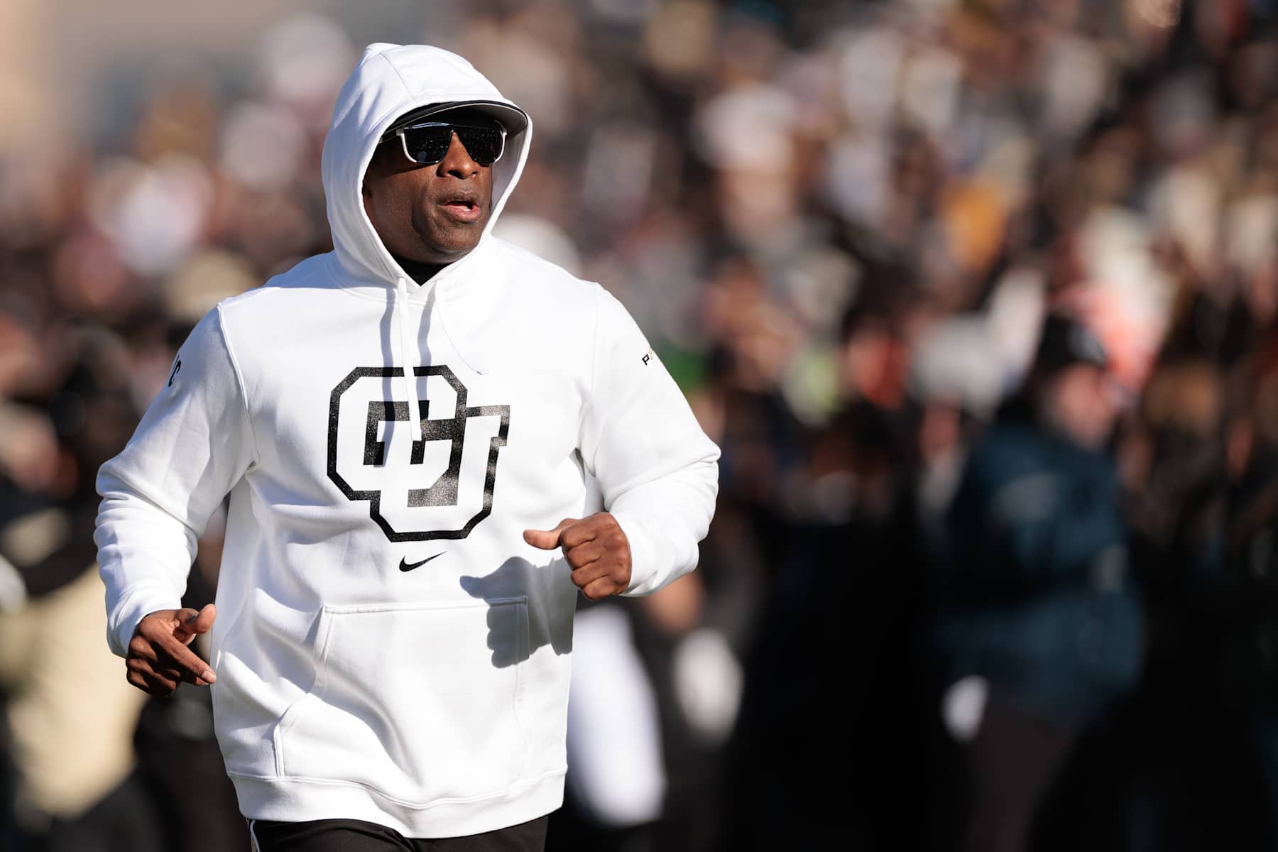 BOULDER, COLORADO - NOVEMBER 29: Head coach Deion Sanders of the Colorado Buffaloes runs out with his team prior to the game against the Oklahoma State Cowboys at Folsom Field on November 29, 2024 in Boulder, Colorado. (Photo by Andrew Wevers/Getty Images)
