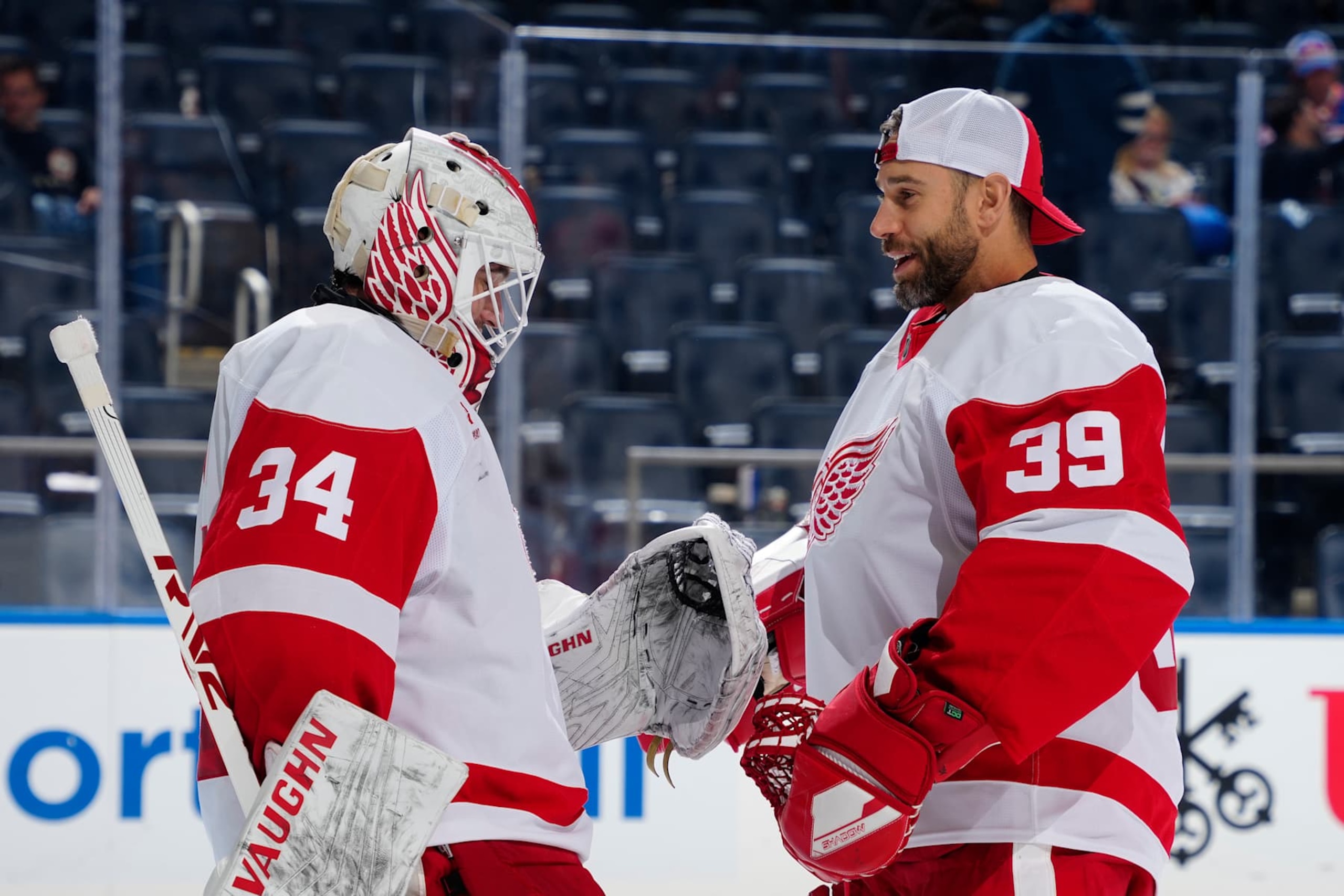 ELMONT, NEW YORK - OCTOBER 22:  Alex Lyon #34 and Cam Talbot #39 of the Detroit Red Wings celebrate their 1-0 win against the New York Islanders at UBS Arena on October 22, 2024 in Elmont, New York. (Photo by Mike Stobe/NHLI via Getty Images)