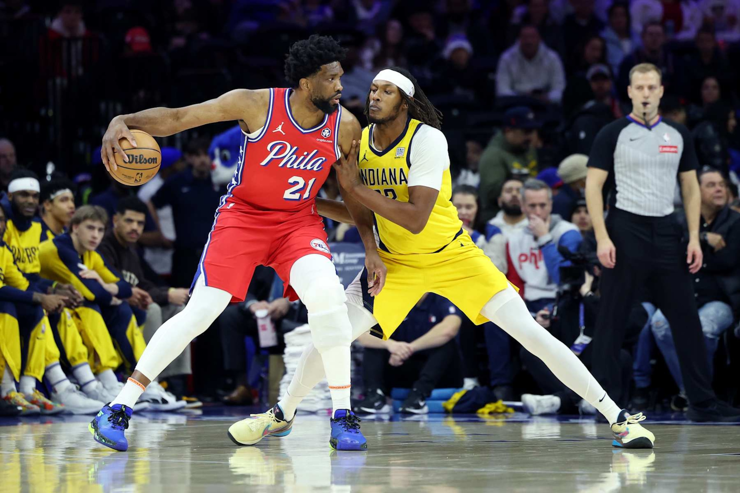 PHILADELPHIA, PENNSYLVANIA - DECEMBER 13: Joel Embiid #21 of the Philadelphia 76ers drives against Myles Turner #33 of the Indiana Pacers during the first half at the Wells Fargo Center on December 13, 2024 in Philadelphia, Pennsylvania. NOTE TO USER: User expressly acknowledges and agrees that, by downloading and or using this photograph, User is consenting to the terms and conditions of the Getty Images License Agreement. (Photo by Emilee Chinn/Getty Images)