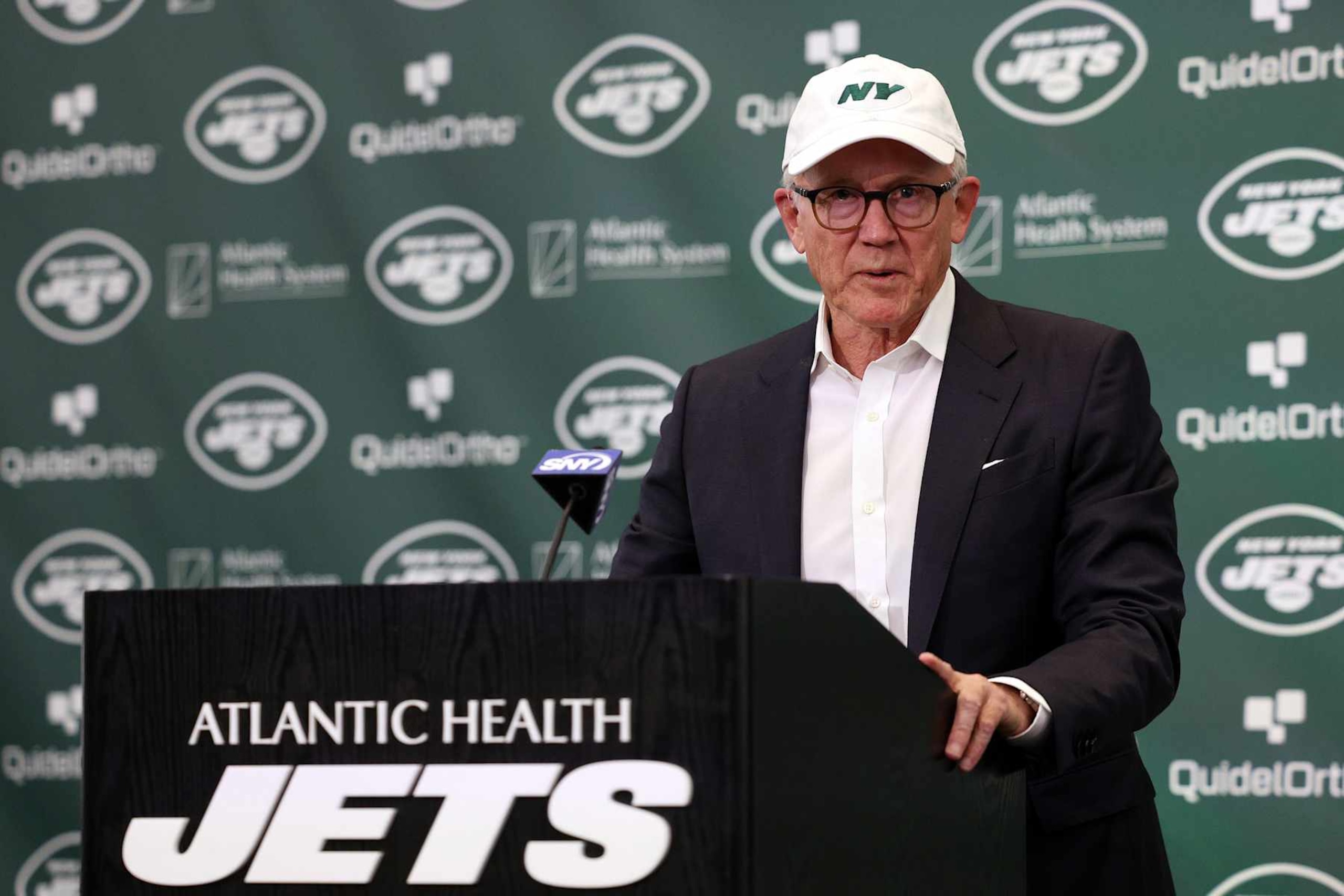 FLORHAM PARK, NEW JERSEY - APRIL 26: New York Jets owner Woody Johnson speaks during an introductory press conference for quarterback Aaron Rodgers at Atlantic Health Jets Training Center on April 26, 2023 in Florham Park, New Jersey. (Photo by Elsa/Getty Images)