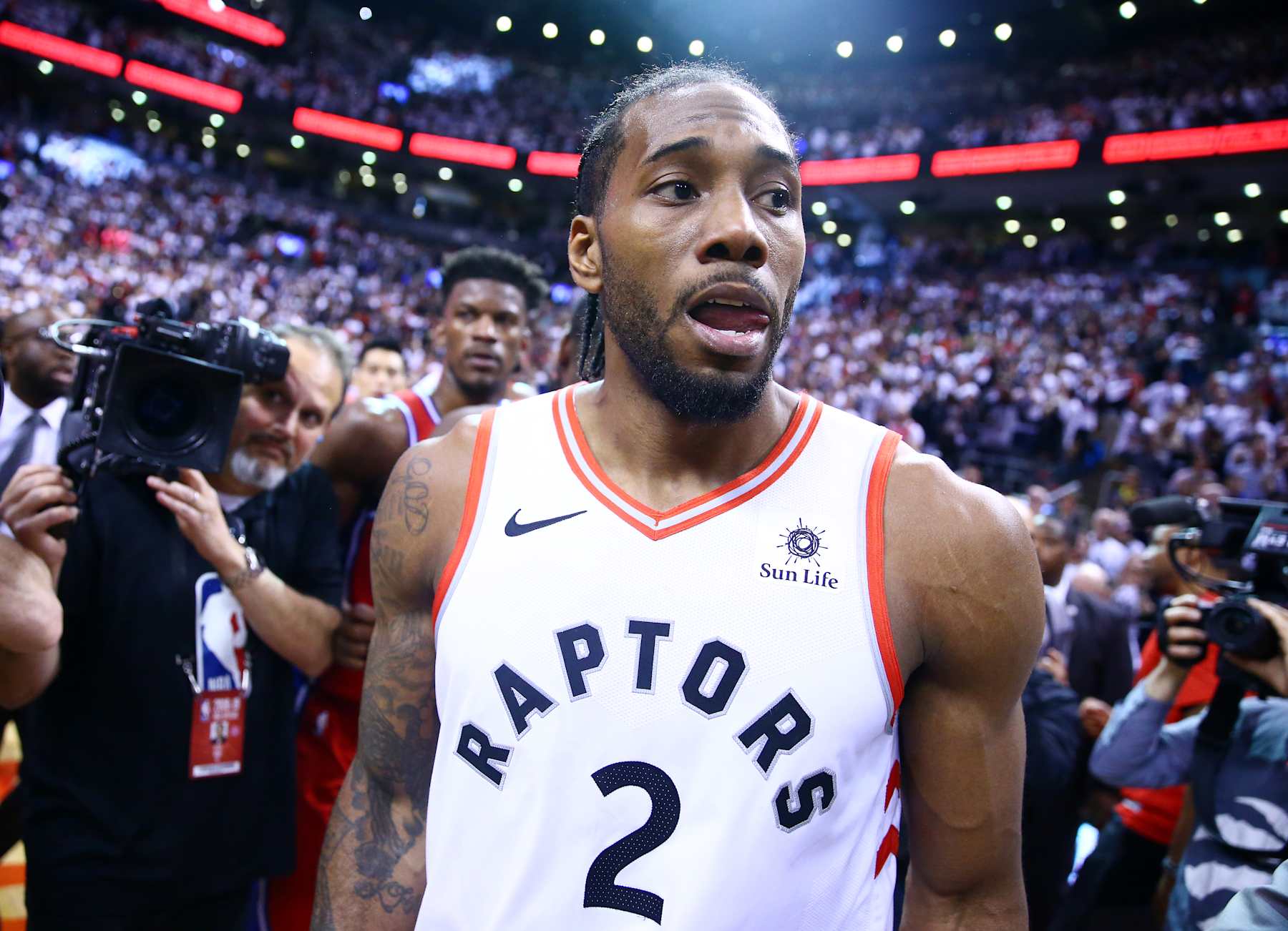 TORONTO, ON - MAY 12:  Kawhi Leonard #2 of the Toronto Raptors looks on after sinking a buzzer beater to win Game Seven of the second round of the 2019 NBA Playoffs against the Philadelphia 76ers at Scotiabank Arena on May 12, 2019 in Toronto, Canada.  NOTE TO USER: User expressly acknowledges and agrees that, by downloading and or using this photograph, User is consenting to the terms and conditions of the Getty Images License Agreement.  (Photo by Vaughn Ridley/Getty Images)