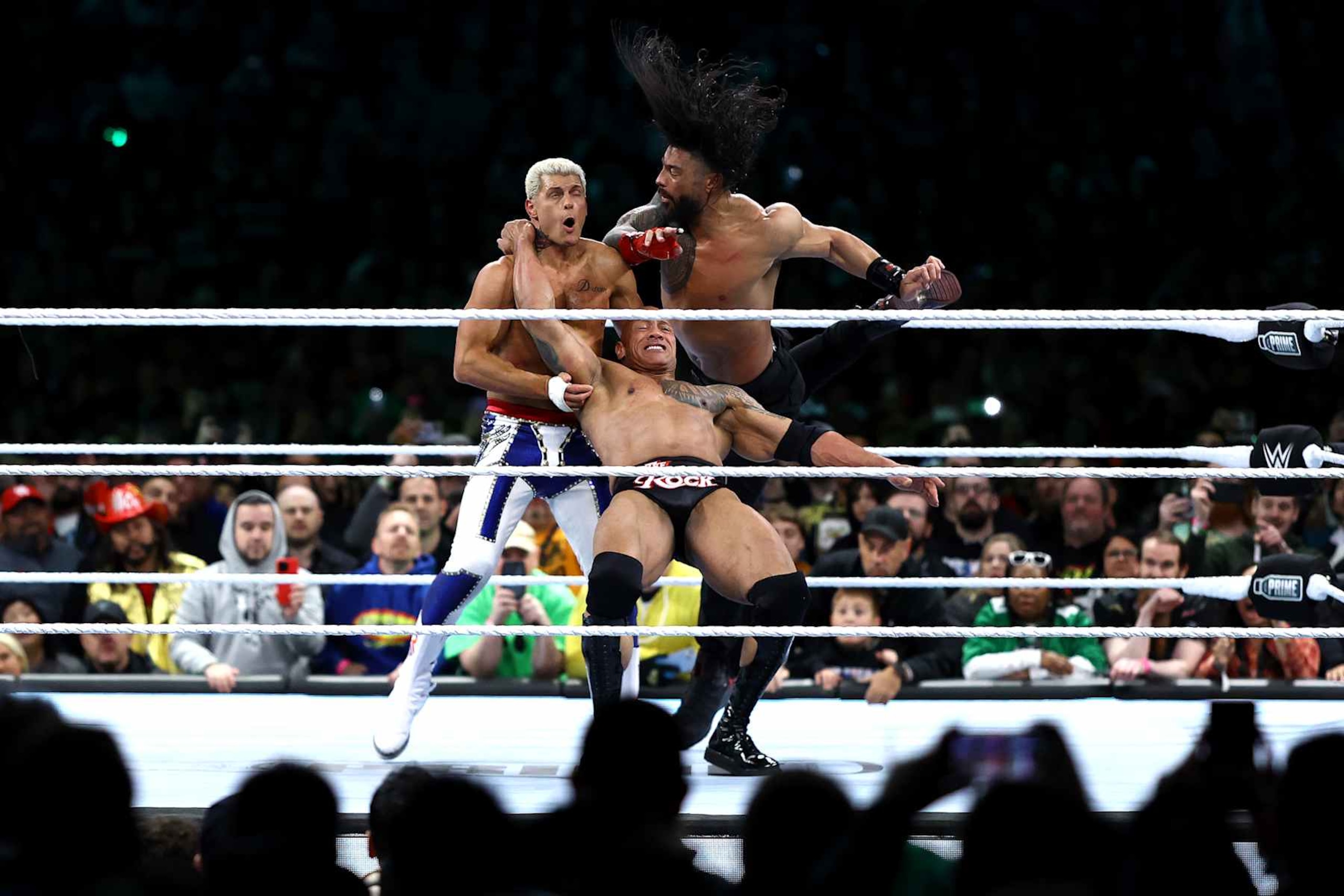 PHILADELPHIA, PENNSYLVANIA - APRIL 06: Cody Rhodes is hit by Dwayne "The Rock" Johnson and Roman Reigns during a fight during Night One of WrestleMania 40 at Lincoln Financial Field on April 06, 2024 in Philadelphia, Pennsylvania. (Photo by Tim Nwachukwu/Getty Images) PHILADELPHIA, PENNSYLVANIA - APRIL 06: Cody Rhodes is hit by Dwayne "The Rock" Johnson and Roman Reigns during a fight during Night One of WrestleMania 40 at Lincoln Financial Field on April 06, 2024 in Philadelphia, Pennsylvania. (Photo by Tim Nwachukwu/Getty Images)