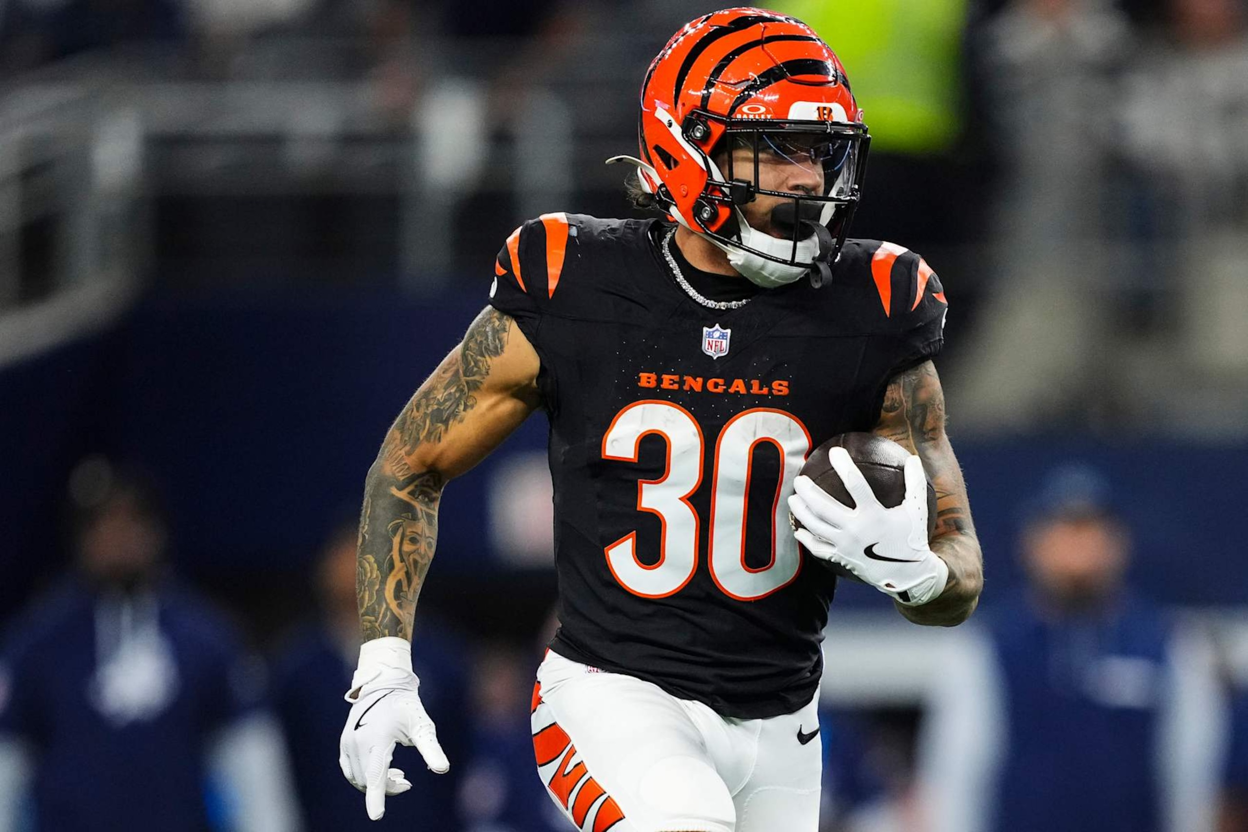 ARLINGTON, TX - DECEMBER 09: Chase Brown #30 of the Cincinnati Bengals runs the ball during an NFL football game against the Dallas Cowboys at AT&T Stadium on December 9, 2024 in Arlington, Texas. (Photo by Cooper Neill/Getty Images)