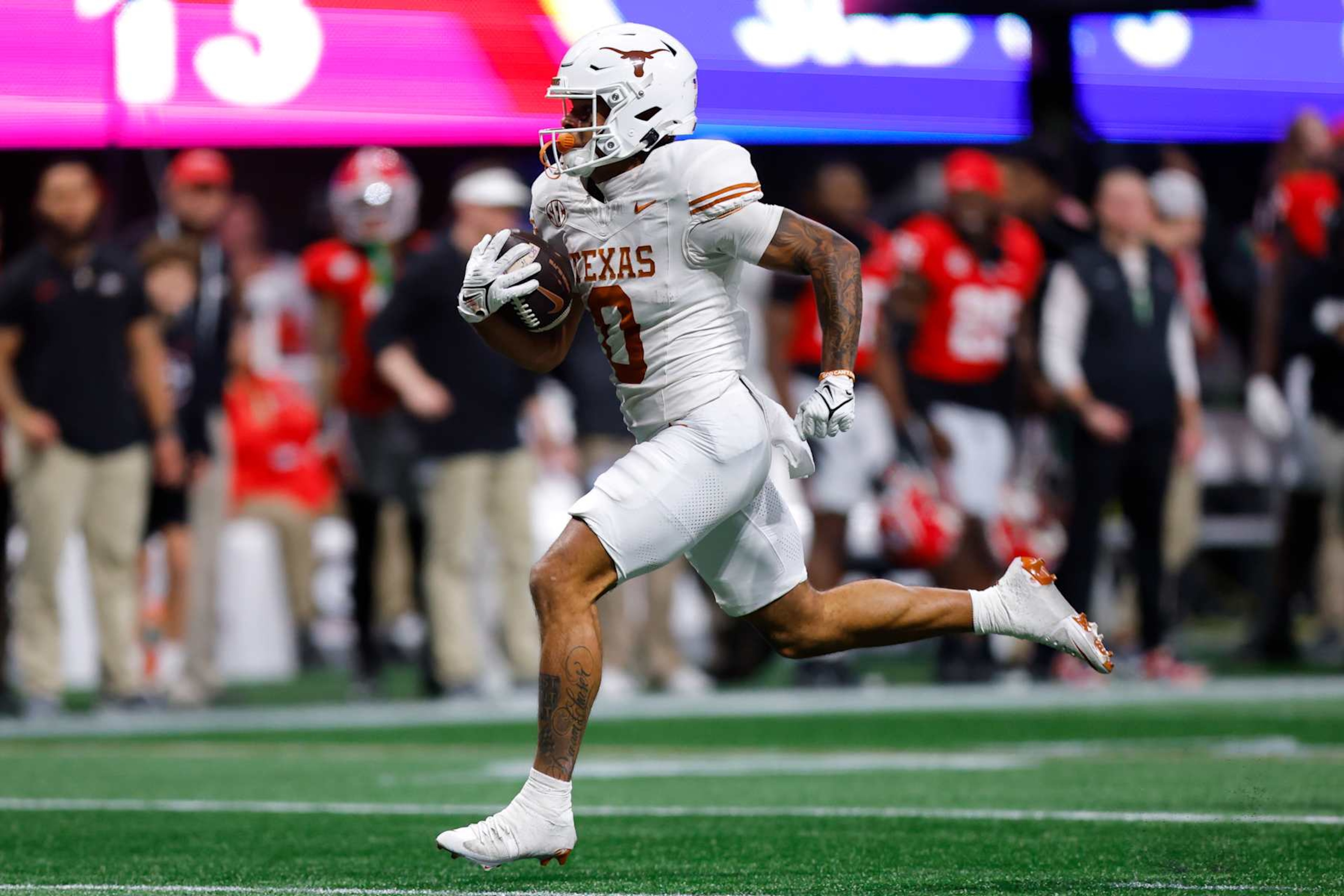 ATLANTA, GEORGIA - DECEMBER 7: DeAndre Moore Jr. #0 of the Texas Longhorns breaks away for a touchdown during the fourth quarter against the Georgia Bulldogs in the 2024 SEC Championship at Mercedes-Benz Stadium on December 7, 2024 in Atlanta, Georgia. (Photo by Todd Kirkland/Getty Images)