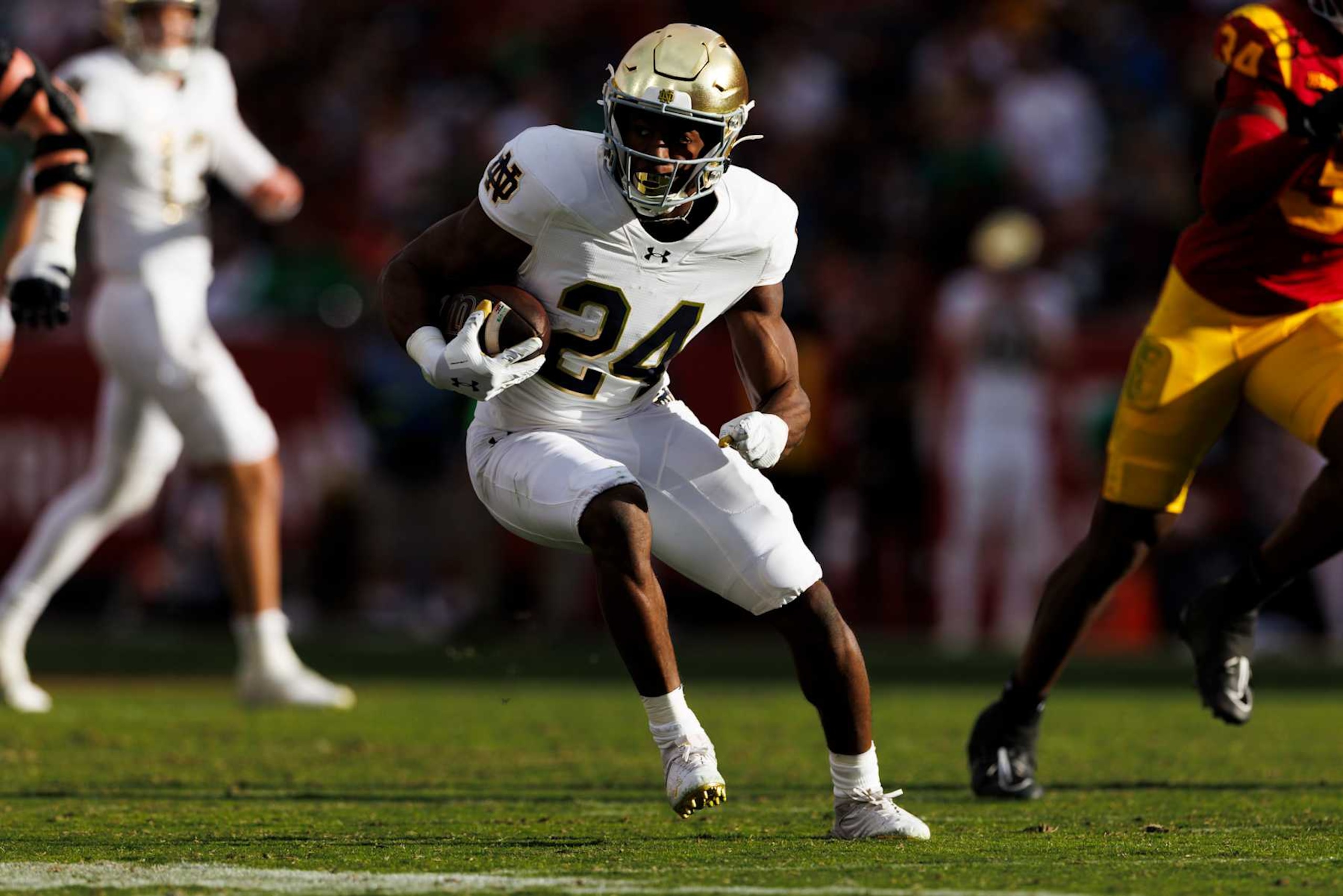 LOS ANGELES, CALIFORNIA - NOVEMBER 30: Jadarian Price #24 of the Notre Dame Fighting Irish runs with the ball during the second half against USC Trojans at United Airlines Field at the Los Angeles Memorial Coliseum on November 30, 2024 in Los Angeles, California. (Photo by Ric Tapia/Getty Images)