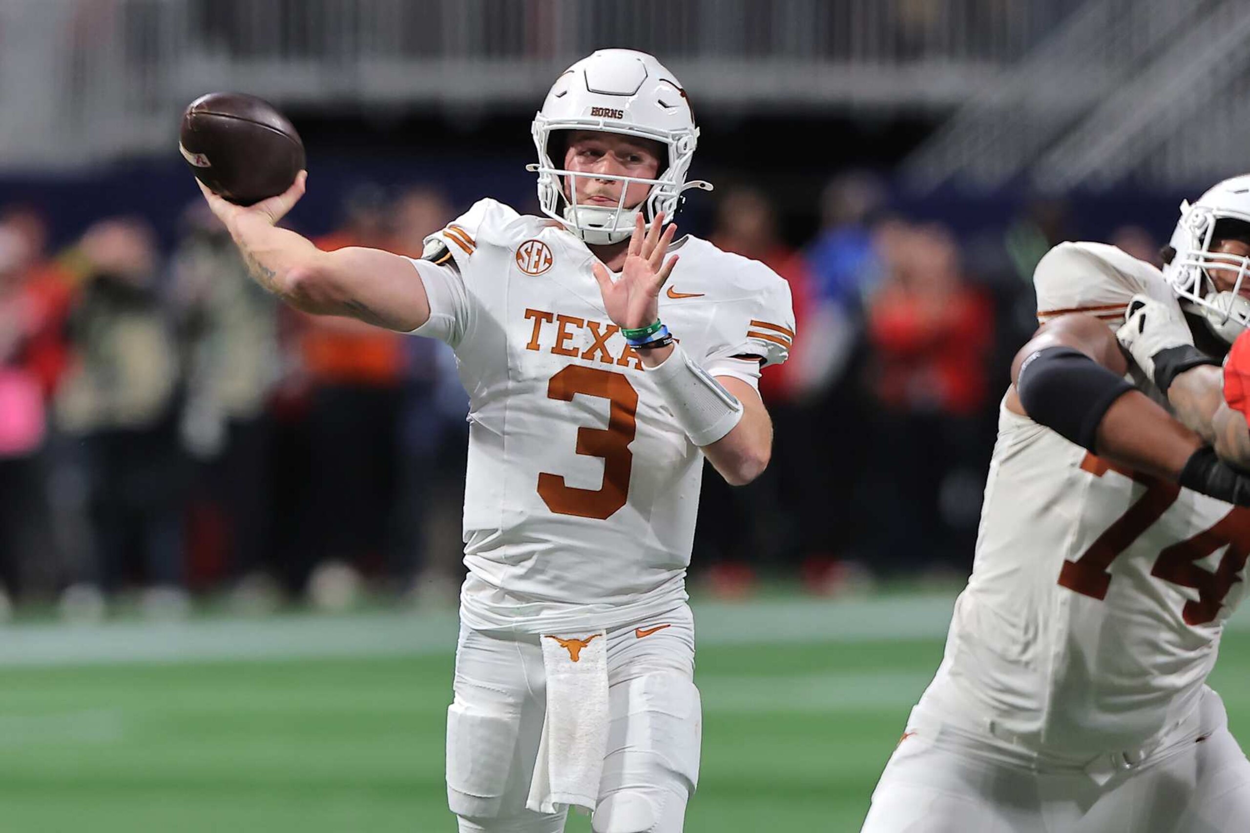 ATLANTA, GA - DECEMBER 07: Texas Longhorns quarterback Quinn Ewers (3) drops back to pass during the SEC championship football game between the Georgia Bulldogs and the Texas Longhorns on December 7, 2024 at the Mercedes-Benz Stadium in Atlanta, Georgia.  (Photo by David J. Griffin/Icon Sportswire via Getty Images)