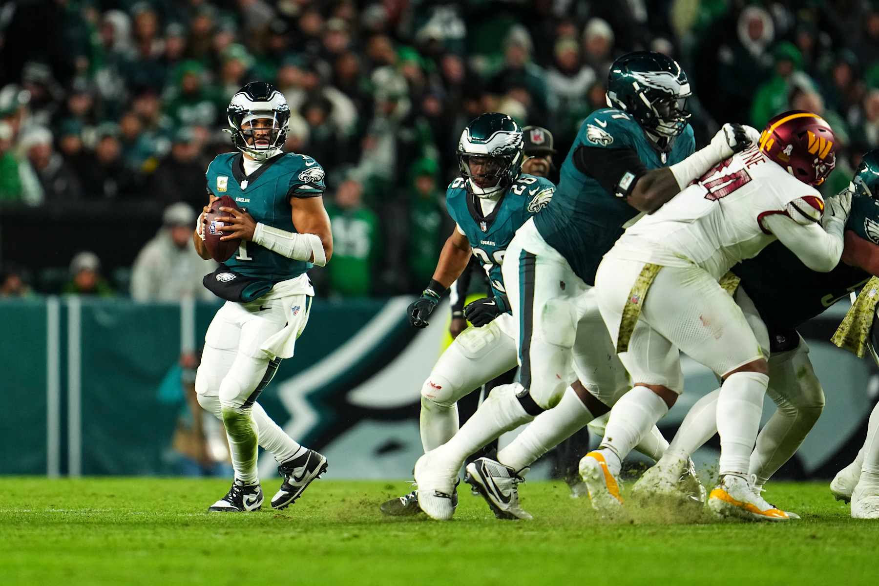 PHILADELPHIA, PA - NOVEMBER 14: Jalen Hurts #1 of the Philadelphia Eagles drops back to pass during an NFL football game against the Washington Commanders at Lincoln Financial Field on November 14, 2024 in Philadelphia, Pennsylvania. (Photo by Cooper Neill/Getty Images)