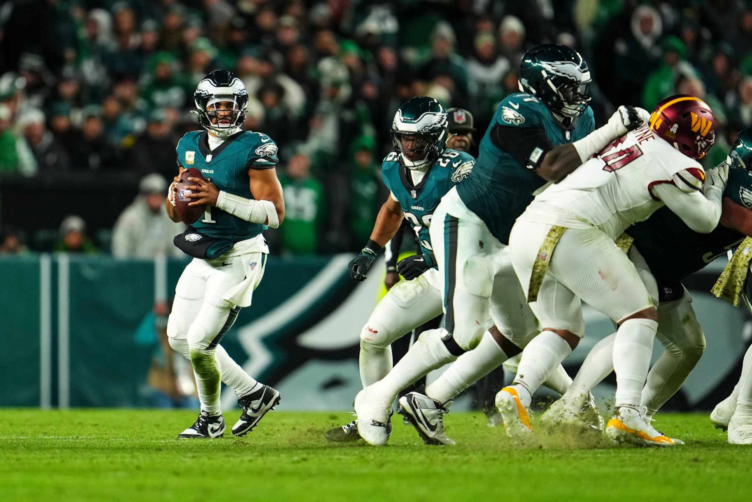 PHILADELPHIA, PA - NOVEMBER 14: Jalen Hurts #1 of the Philadelphia Eagles drops back to pass during an NFL football game against the Washington Commanders at Lincoln Financial Field on November 14, 2024 in Philadelphia, Pennsylvania. (Photo by Cooper Neill/Getty Images)